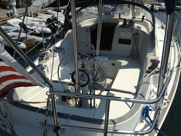 Cockpit of a 1984 C&C Landfall yacht with steering wheel and navigation instruments.