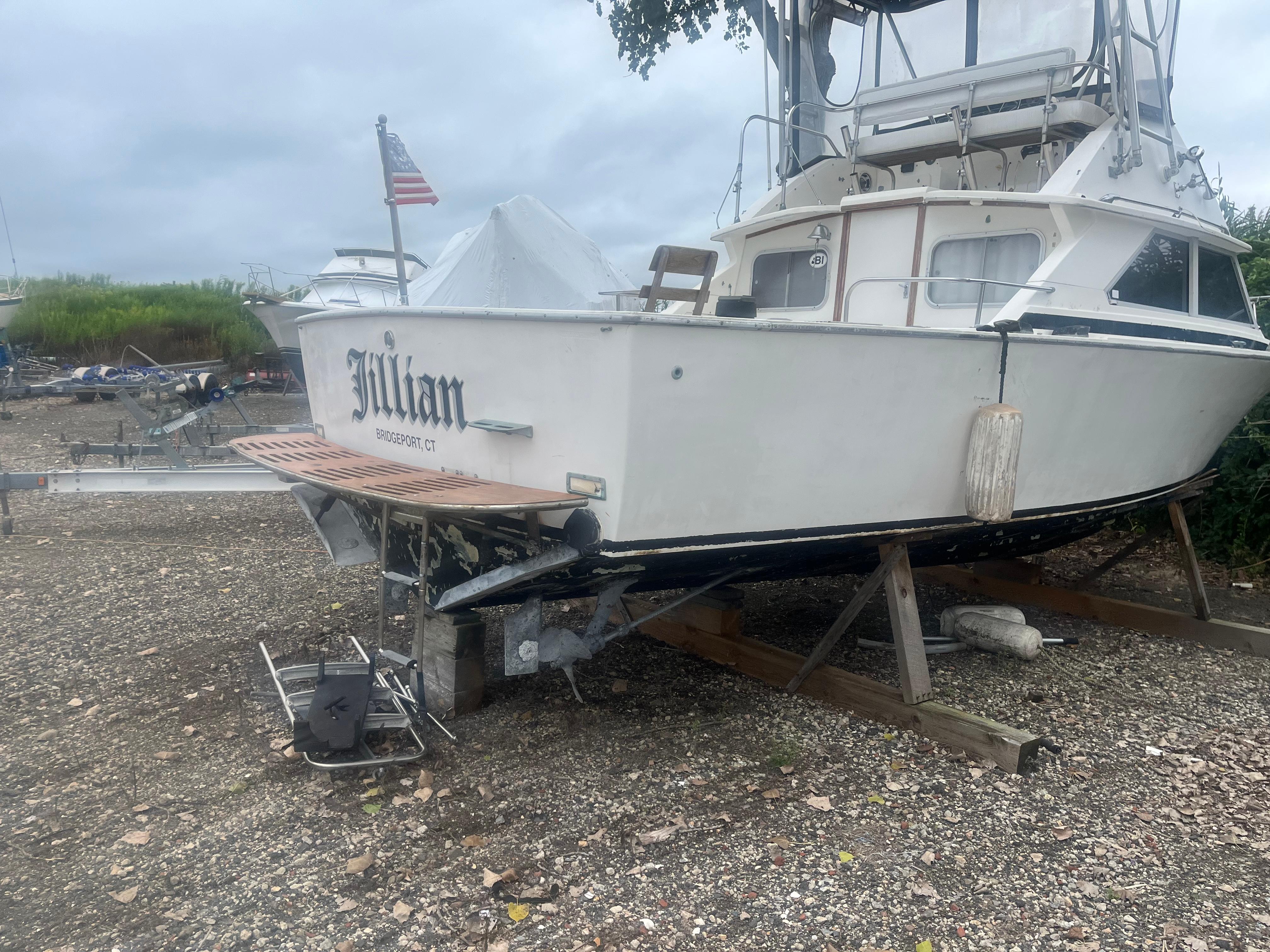 1973 Bertram 28 Flybridge Cruiser on dry land, rear view.