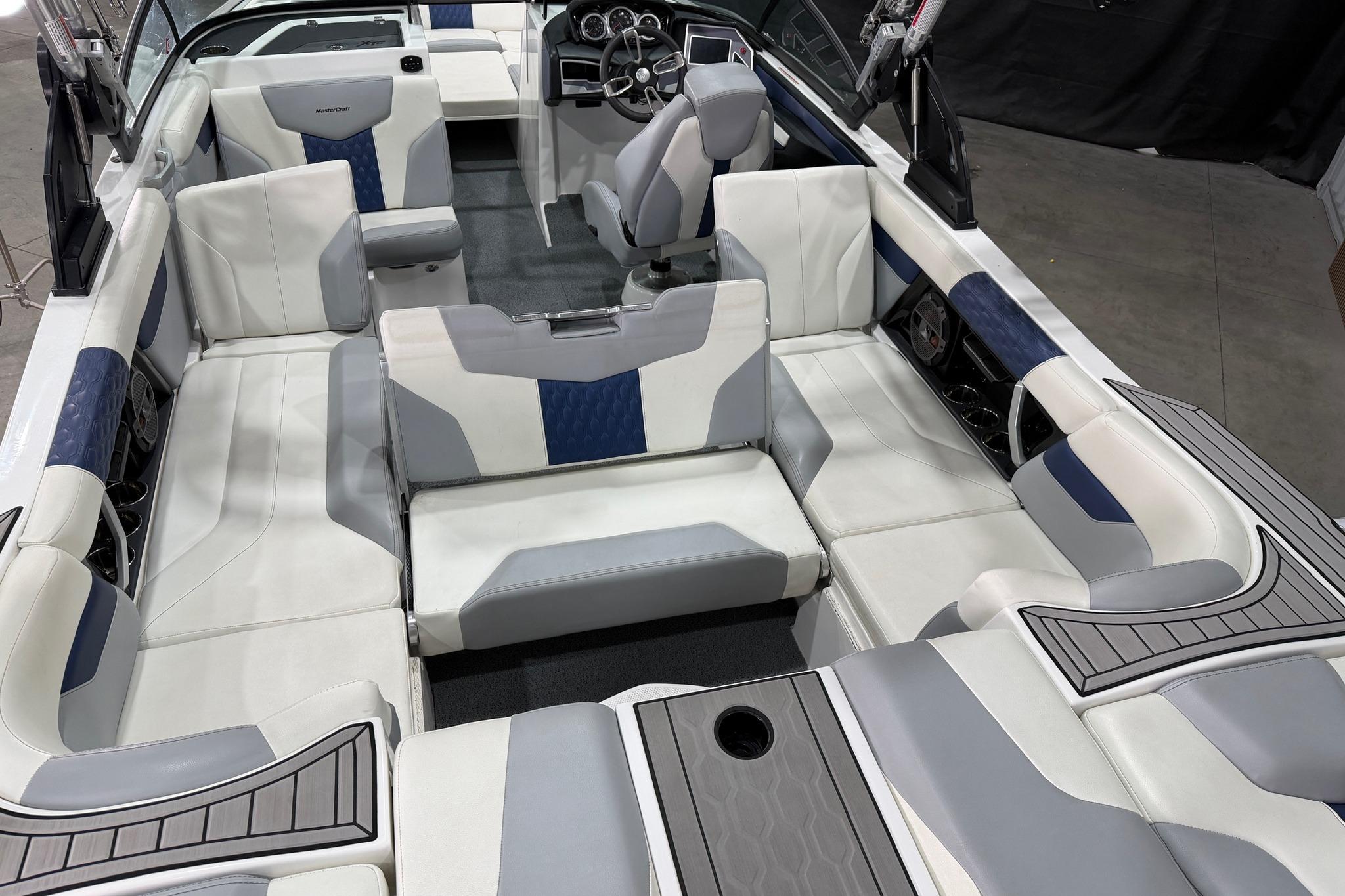 2022 MasterCraft XT24 boat interior with white and blue seating, modern design.