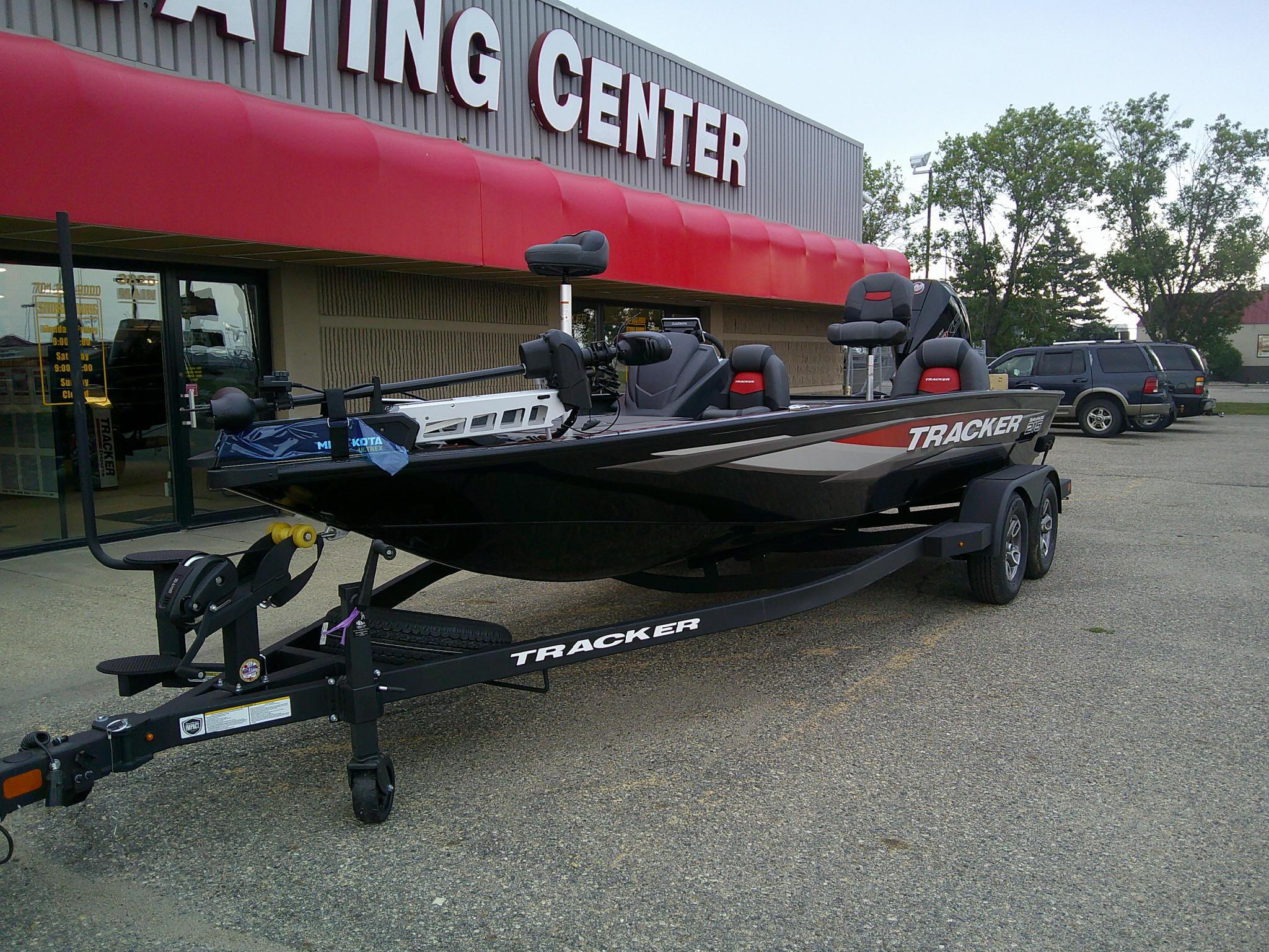2025 Tracker Savage 215 boat on trailer outside a boating center.