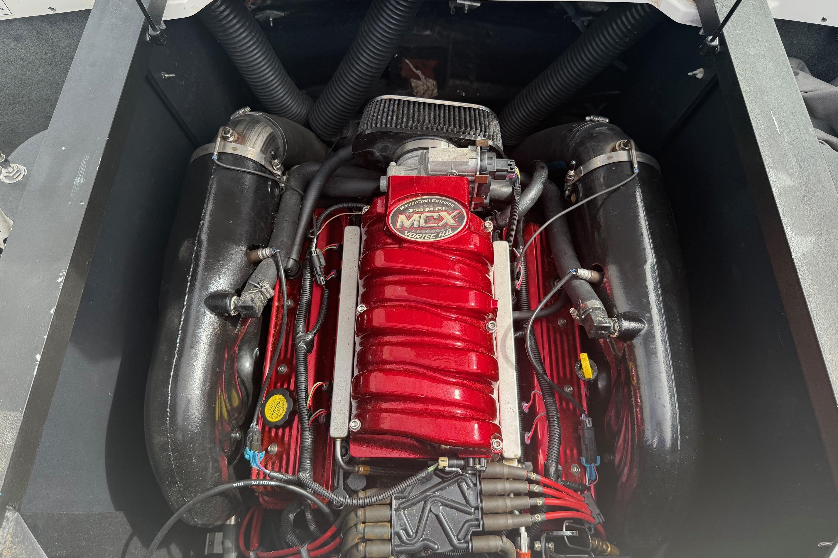 2008 MasterCraft X-15 engine with red MCX Vortec cover, detailed view.