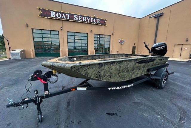 2026 Tracker Grizzly 1650 T Prairie Wings Edition boat on trailer outside service center.