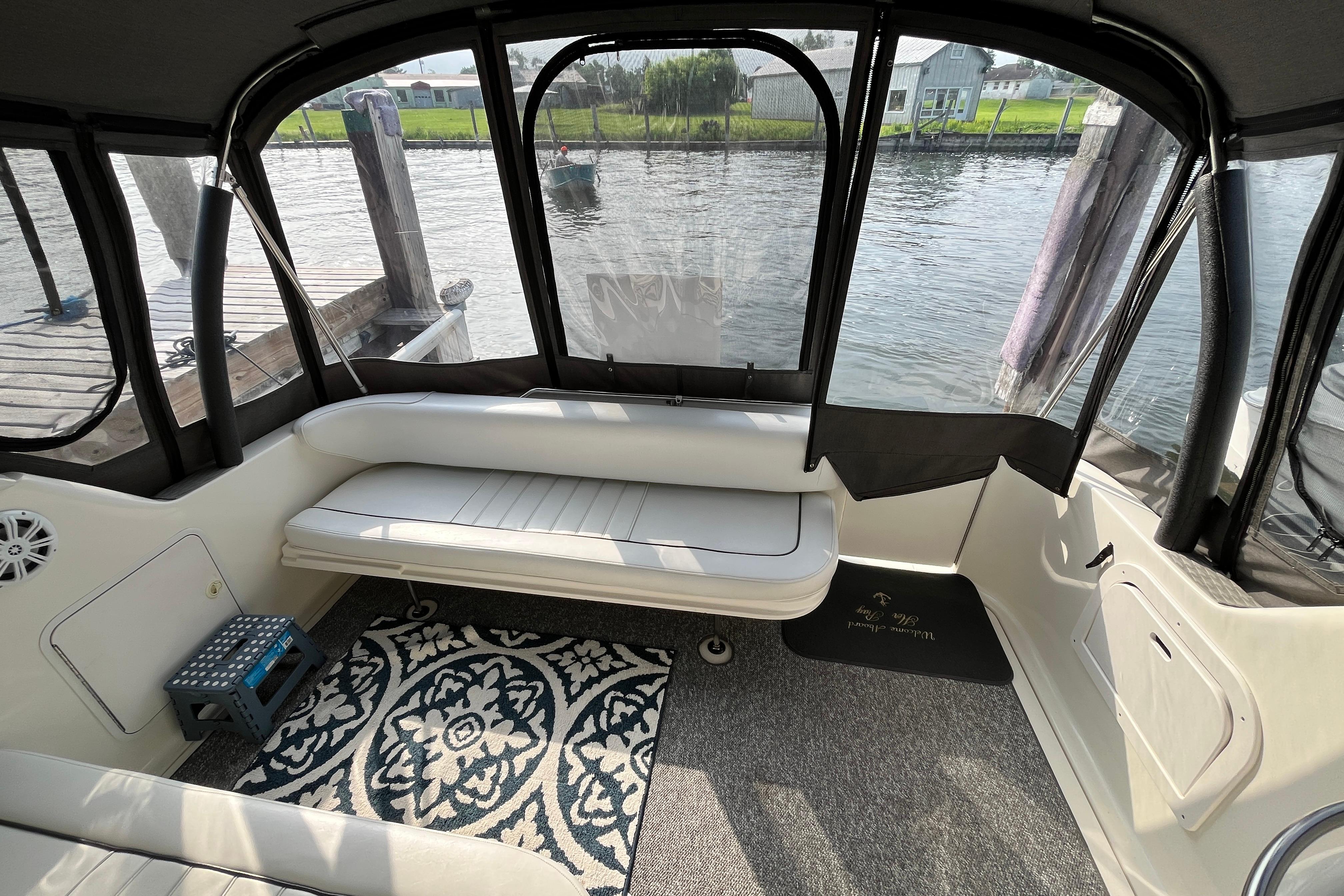 Interior of a 1995 Sea Ray Sundancer 330 boat with seating and waterfront view.