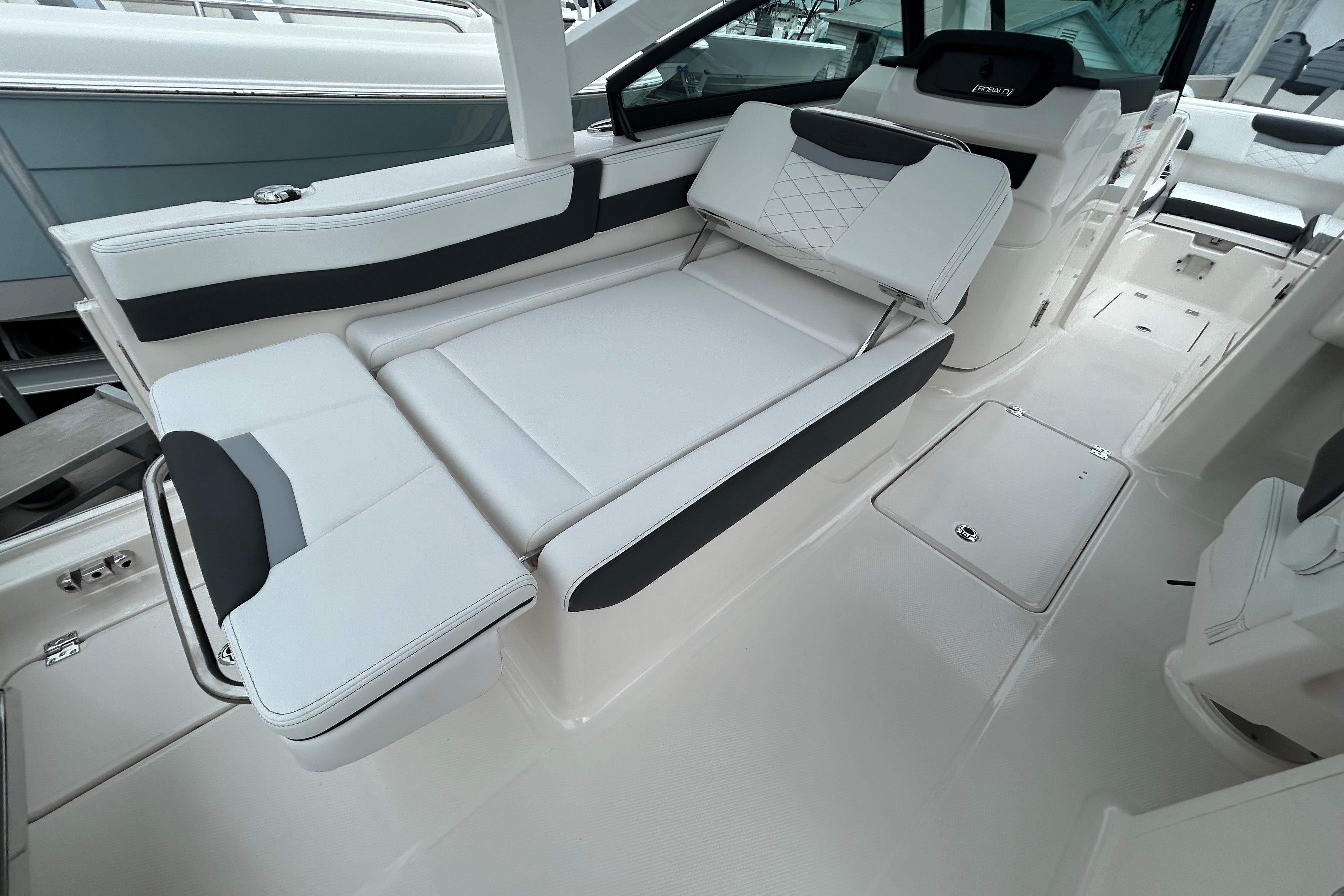 2026 Robalo R257 Dual Console boat interior with sleek white seating and modern design.