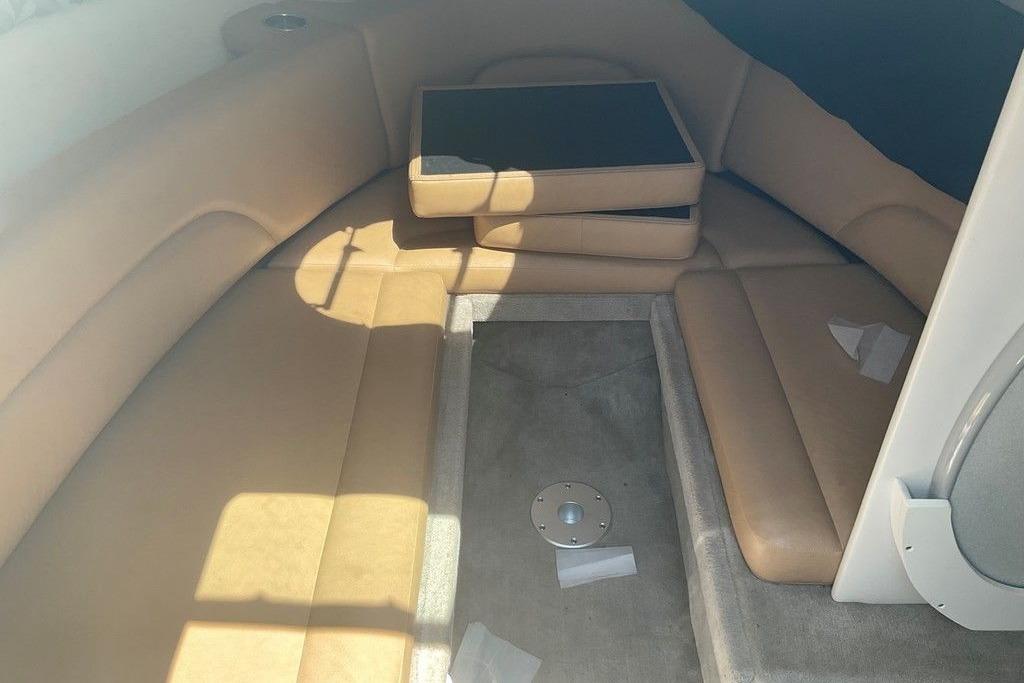 2015 Crownline 236 SC cabin interior with beige seating and carpeted floor.