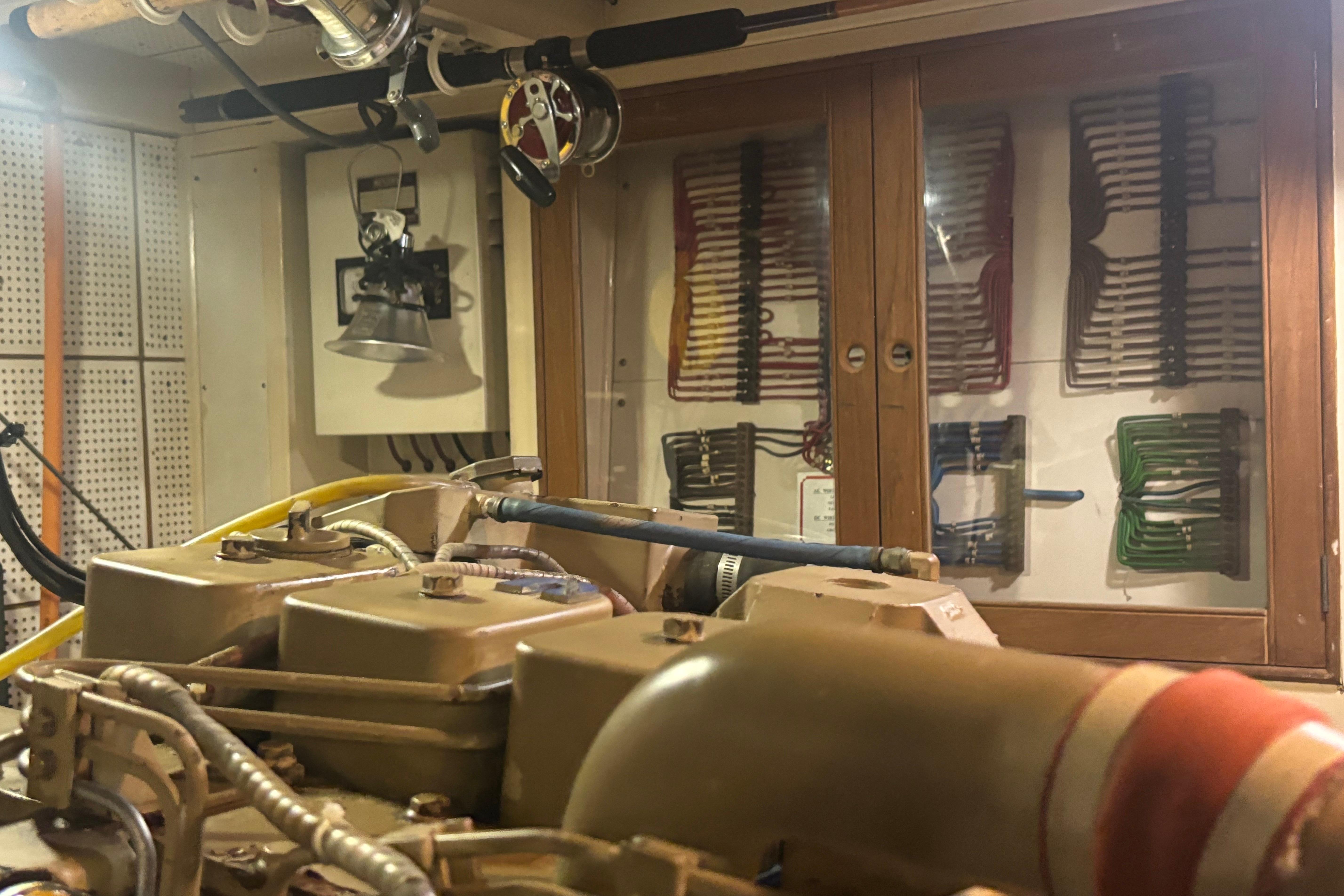 Engine room of 1989 Grand Banks 46 Classic yacht, showcasing mechanical components and wiring.