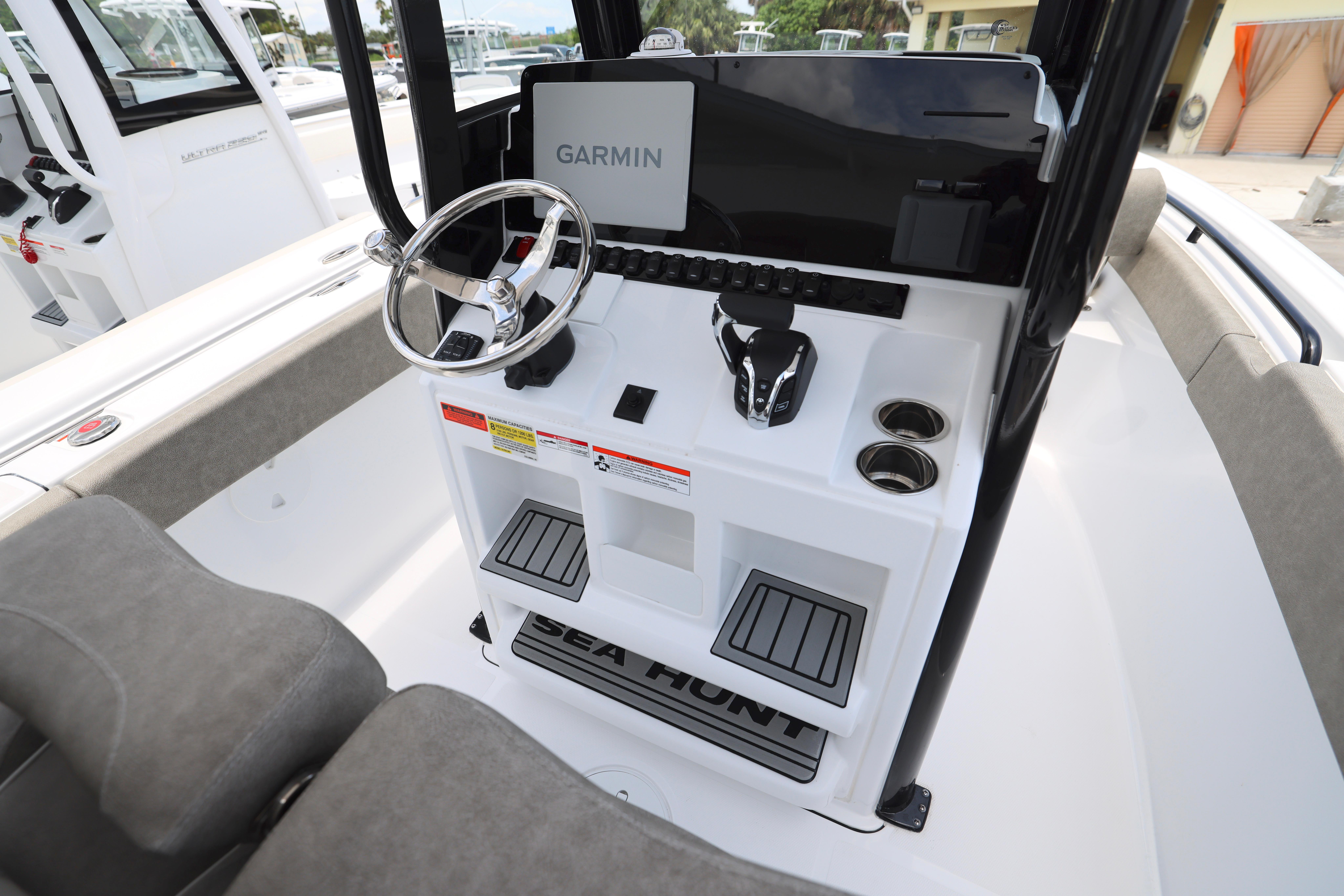 2026 Sea Hunt Ultra 245 SE boat console with Garmin display and steering wheel.