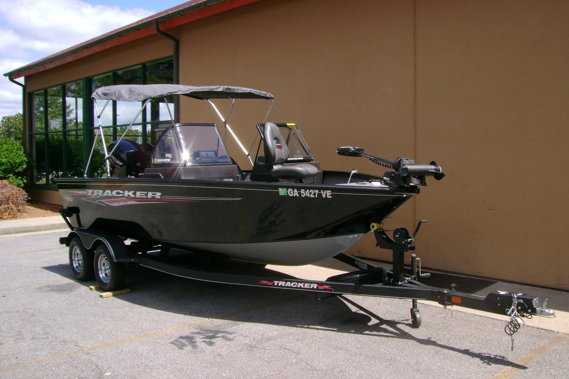 2023 Tracker Pro Guide V-175 WT boat on trailer, parked outdoors.