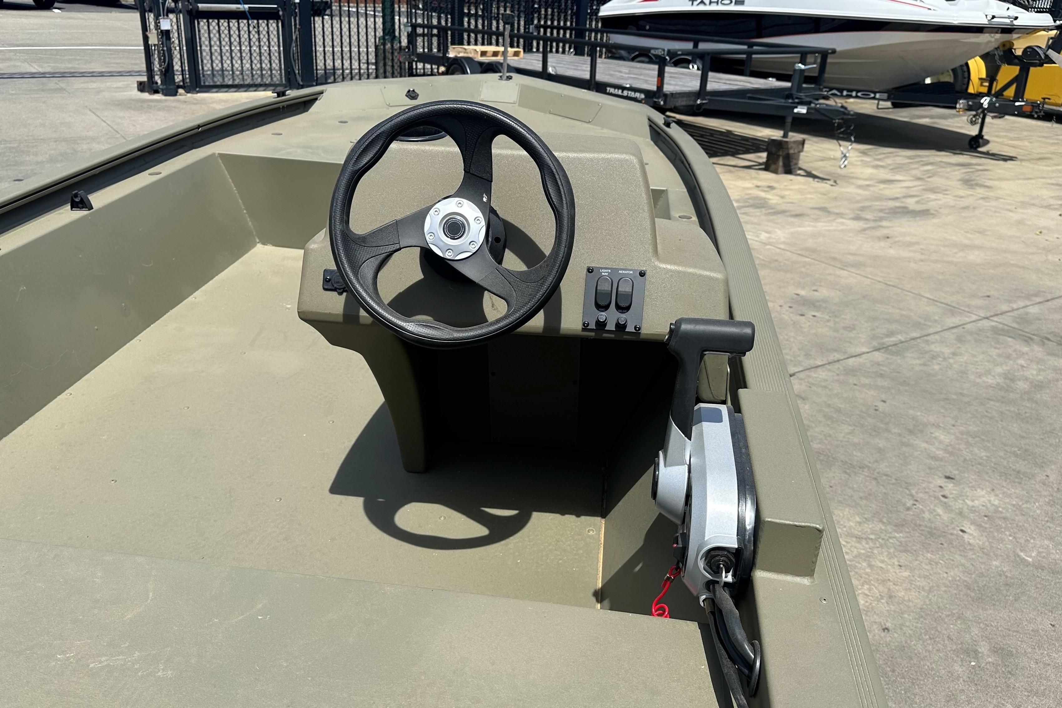 2026 Tracker Grizzly 1648 SC boat interior with steering wheel and controls.