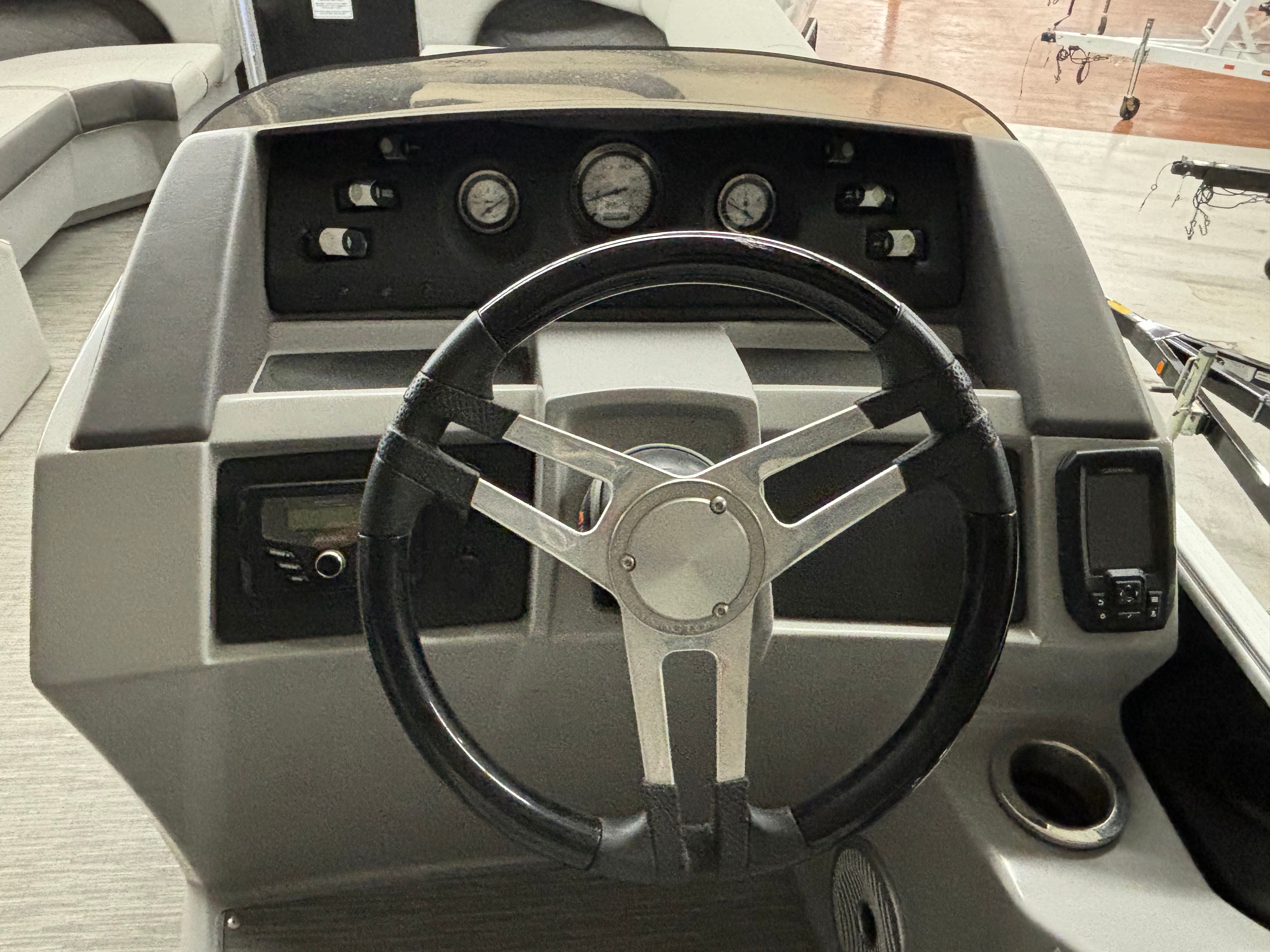 The image shows the helm of a 2022 Bennington L 23 Swingback with instruments and controls.
