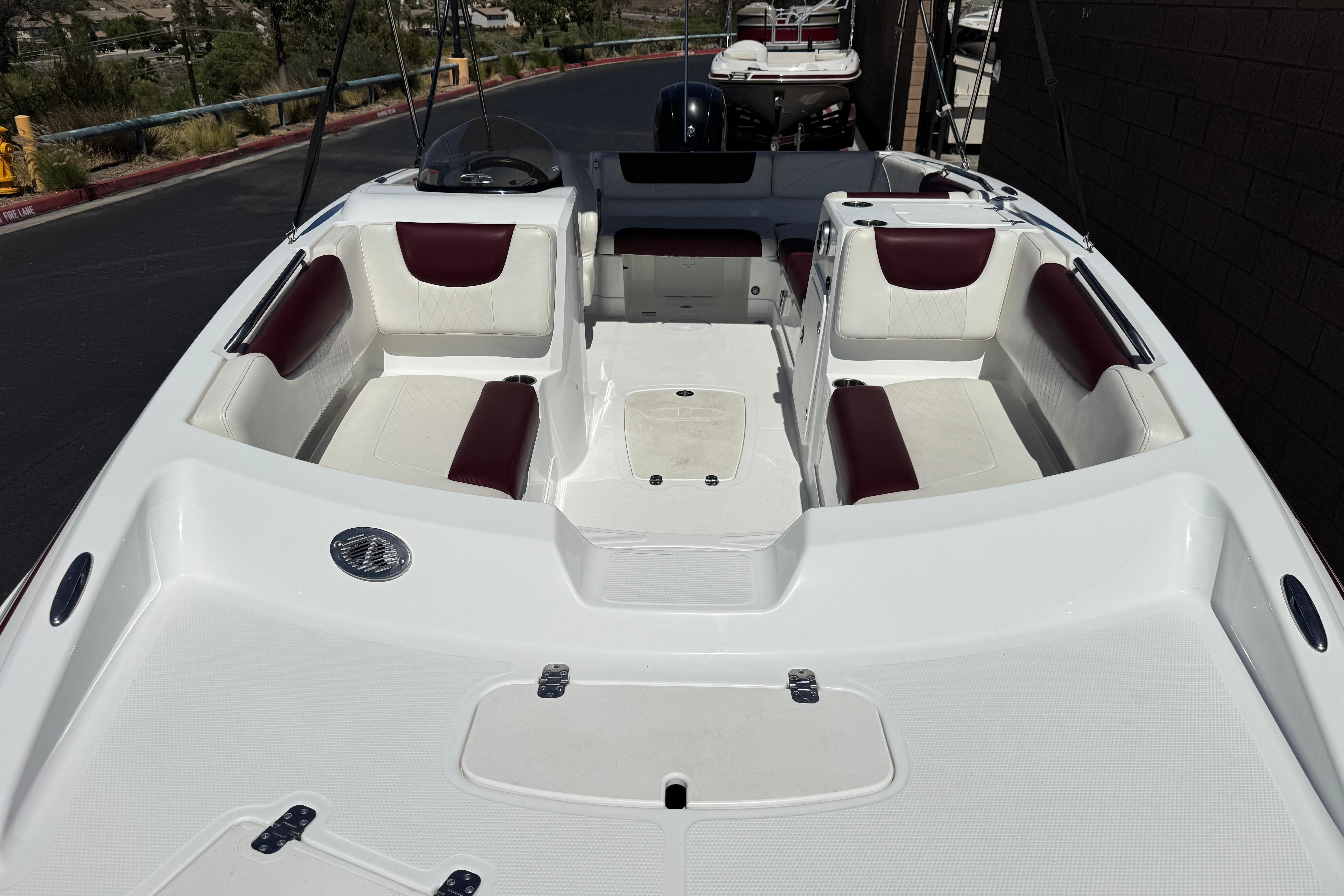 2017 Tahoe 2150 boat interior with white and maroon seating, spacious layout.
