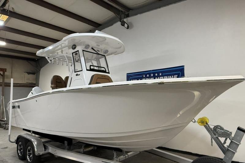 2026 Sea Pro 242 Center Console boat on trailer in indoor storage.