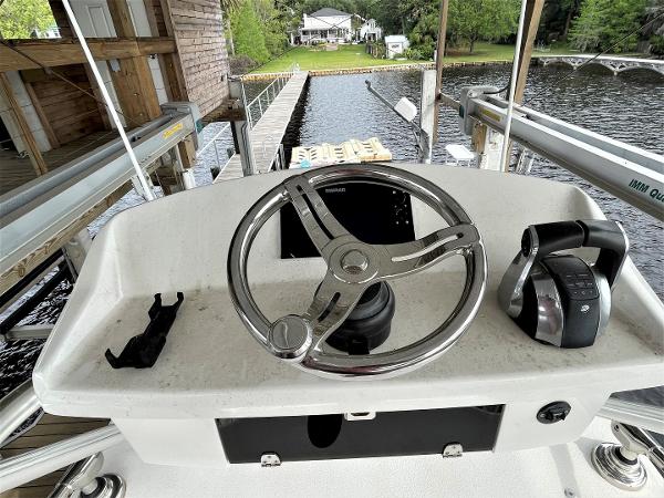 2020 Front Runner 39 Center Console helm with steering wheel and controls, dockside view.