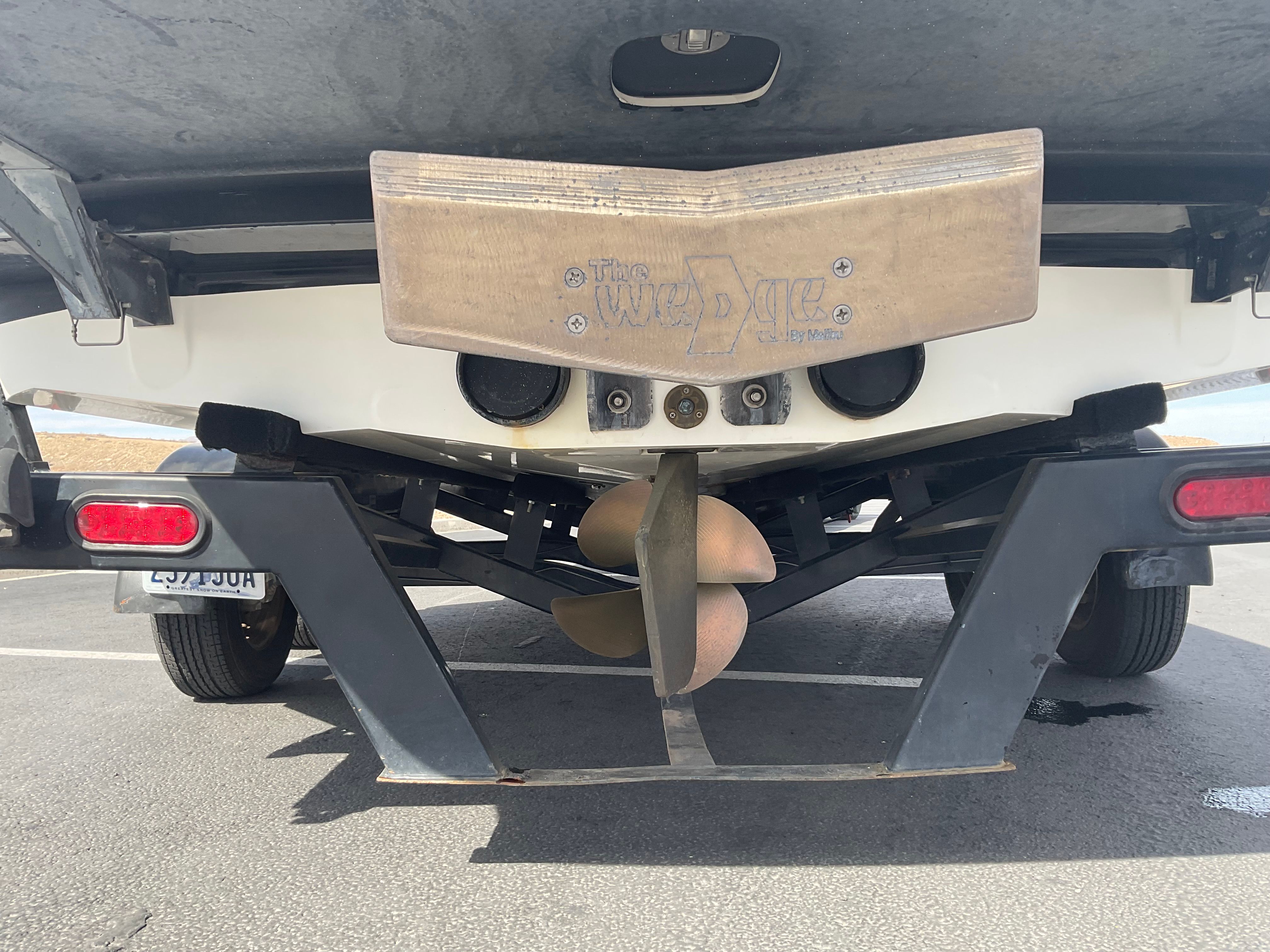 Rear view of a 2003 Malibu Wakesetter 23 LSV with propeller and wedge system.