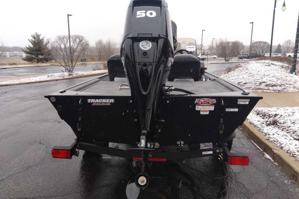 2026 Tracker Bass Tracker Classic XL boat with 50 HP motor in snowy parking lot.