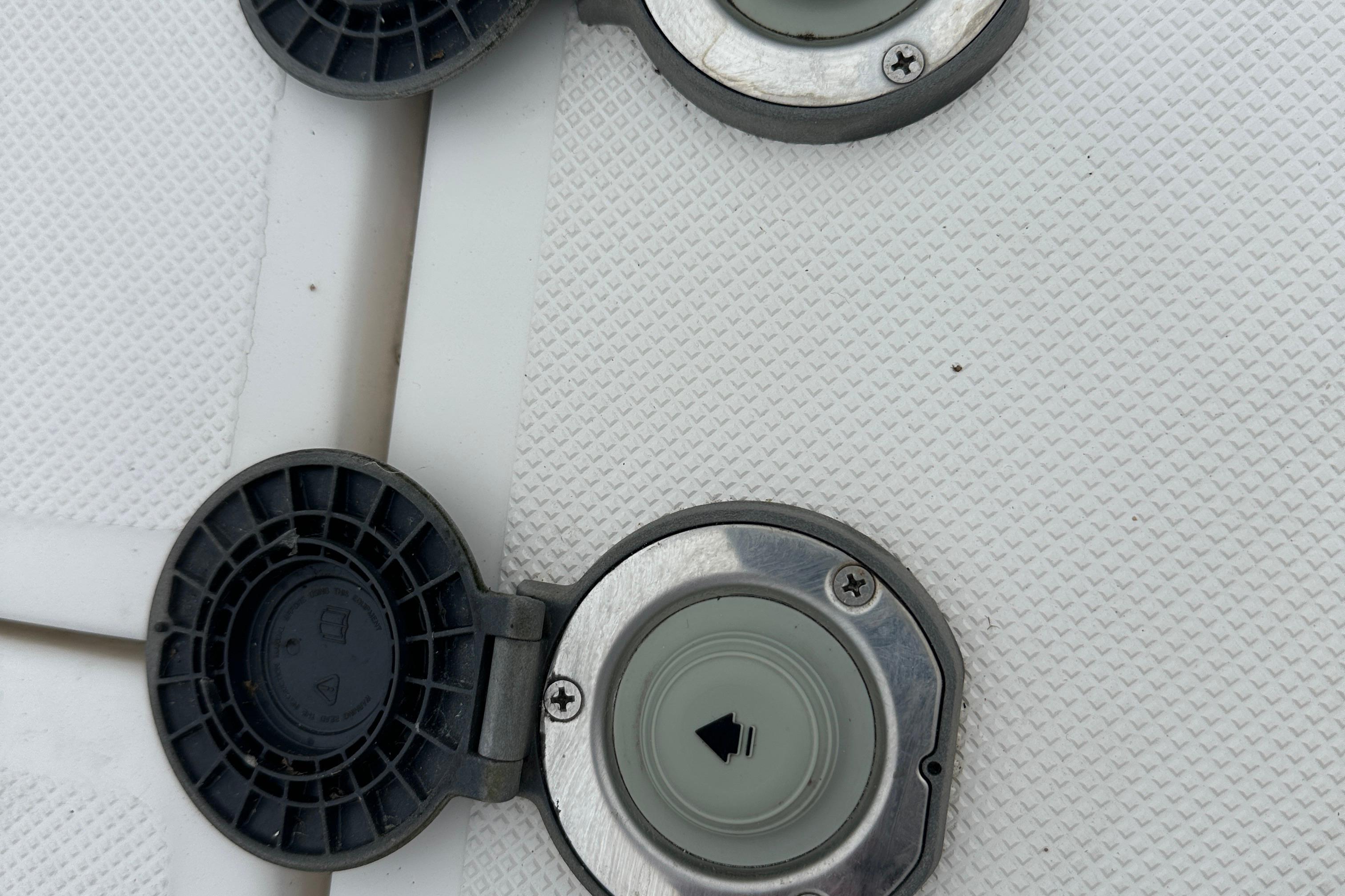 Open fuel caps on a 2016 Regal 35 Sport Coupe boat deck.