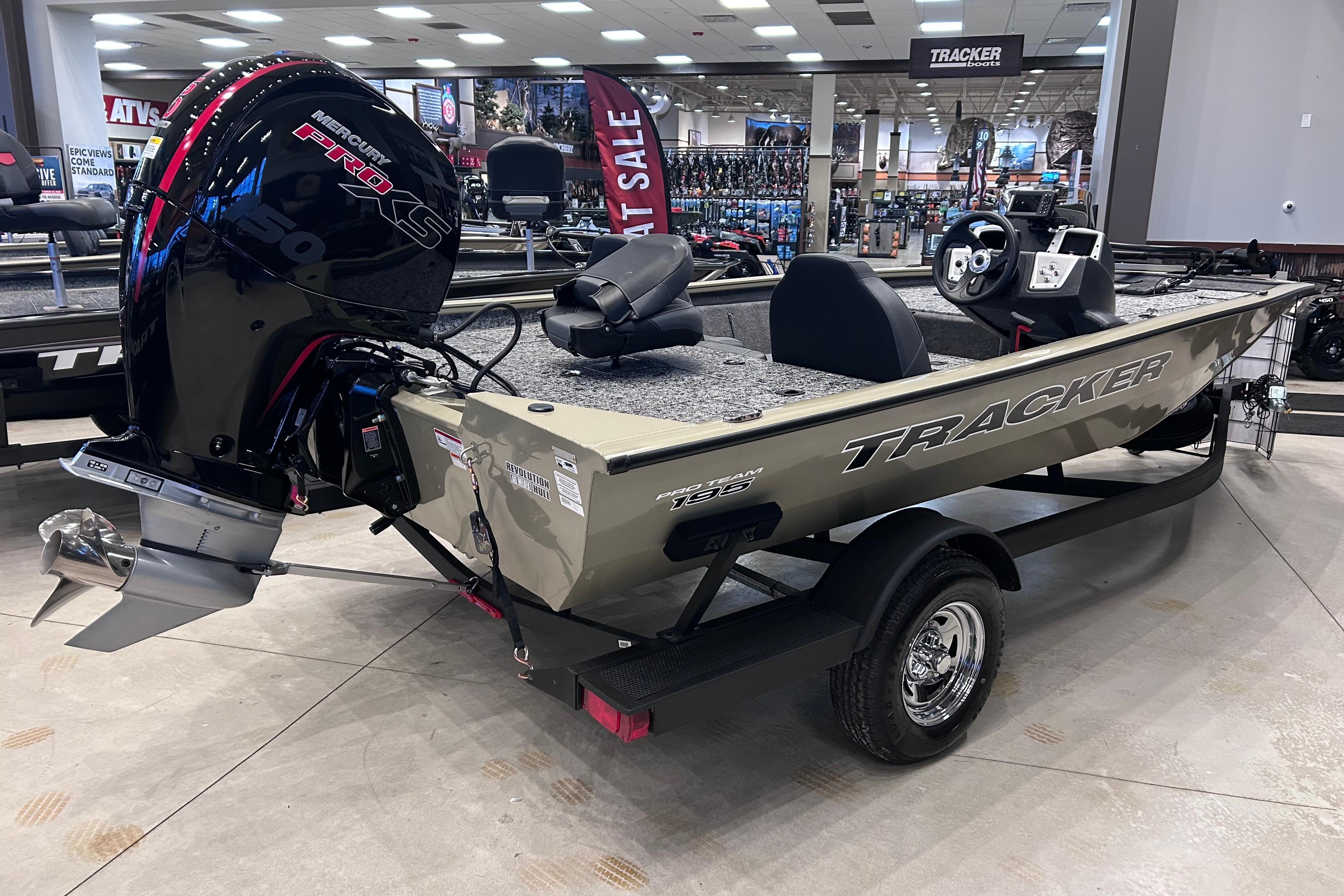 2026 Tracker Pro Team 195 boat with Mercury engine displayed in showroom.