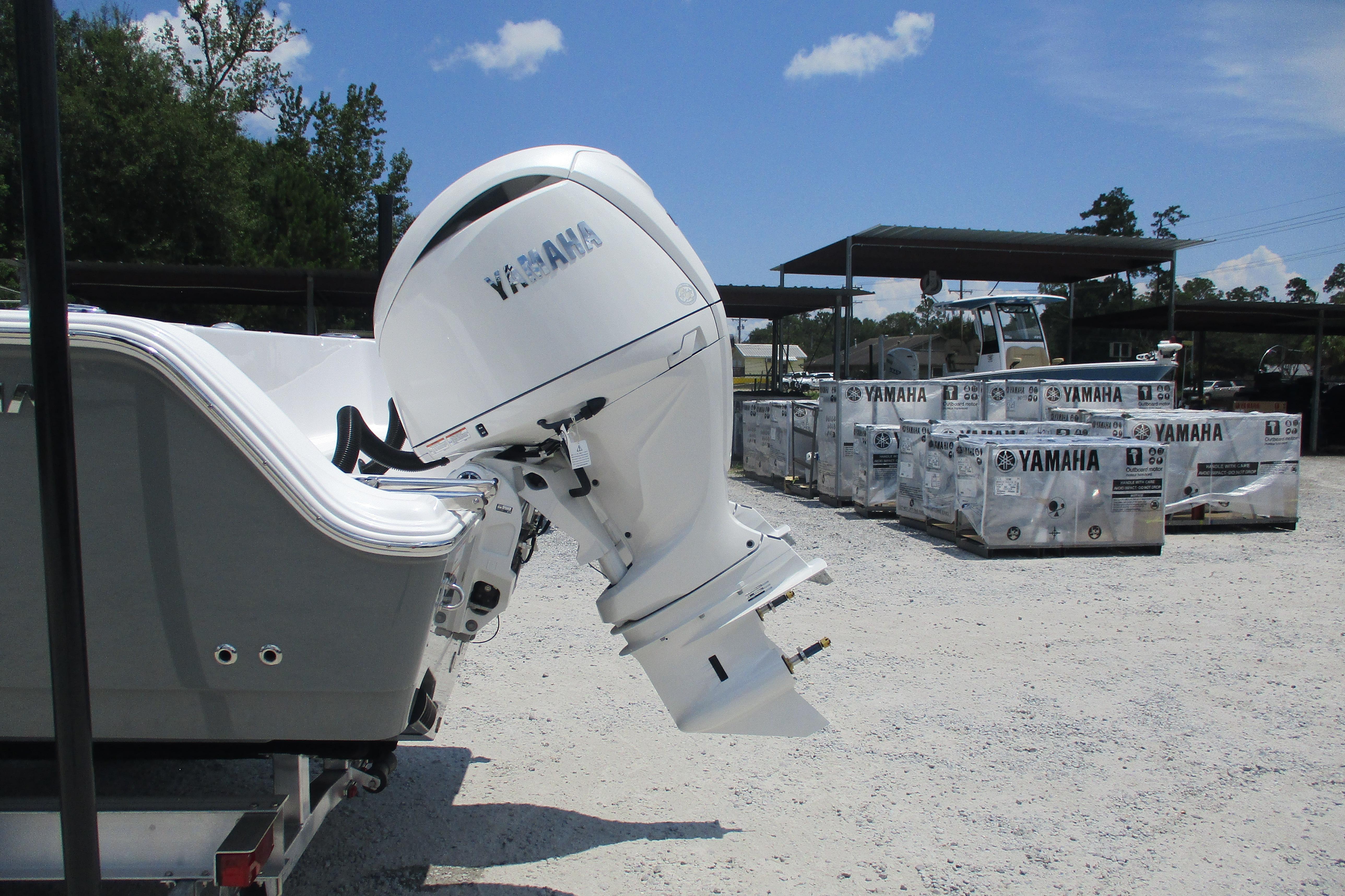 2027 Sportsman Open 252 Center Console with Yamaha outboard motor in a storage yard.