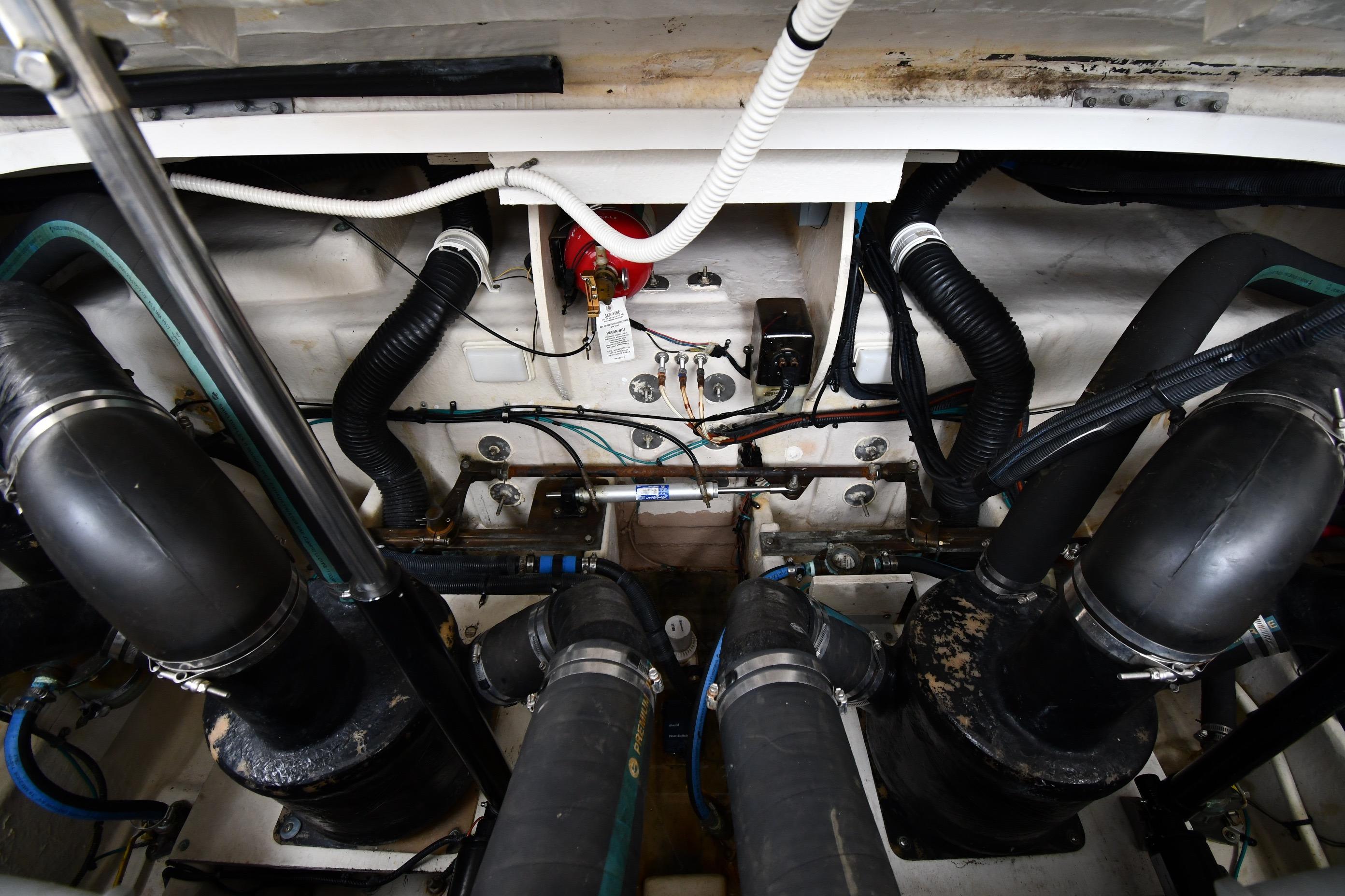 Engine compartment of a 2008 Sea Ray Sundancer 350 with visible hoses and wiring.