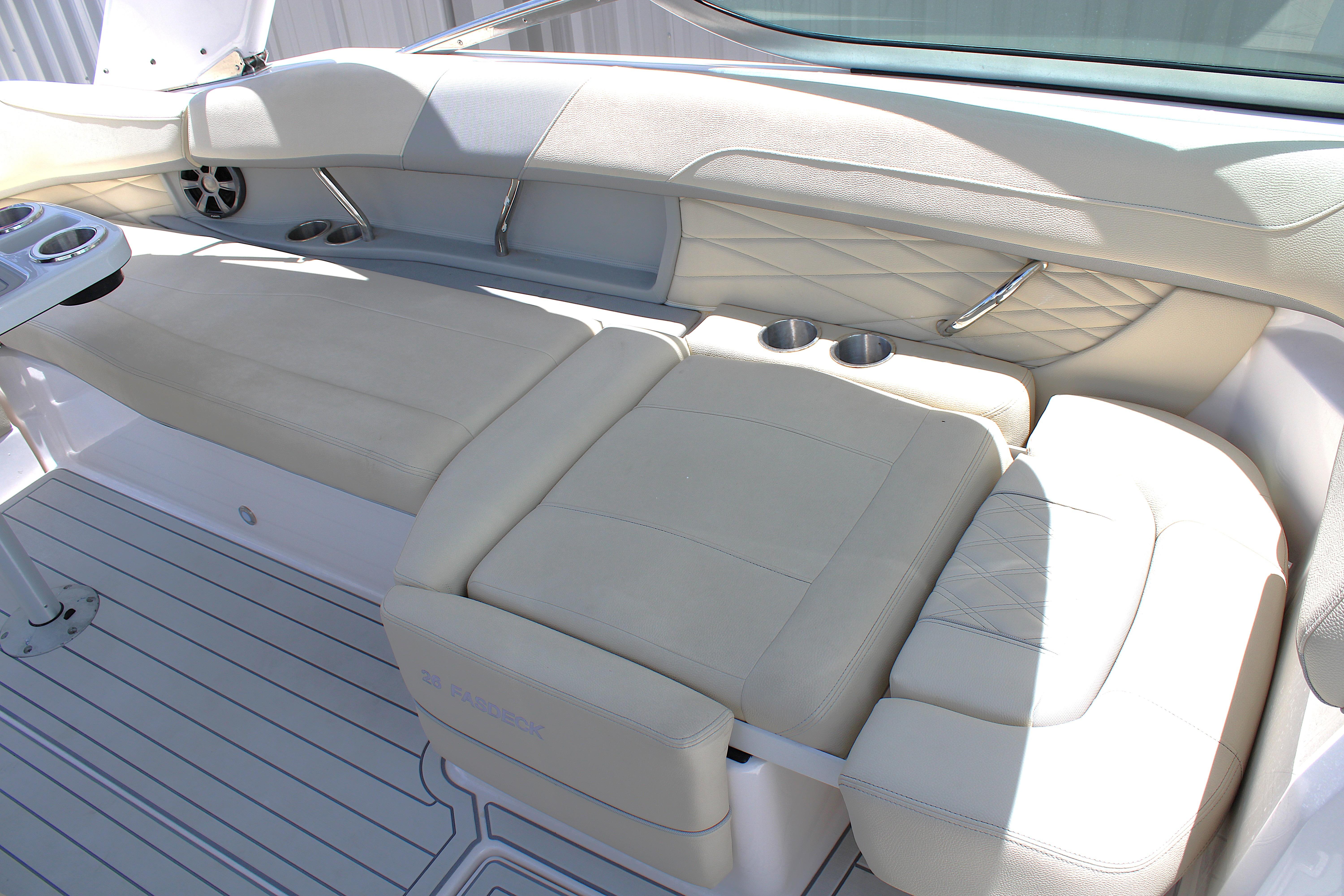 Luxurious seating area on a 2021 Regal 26 OBX boat with cup holders and elegant design.