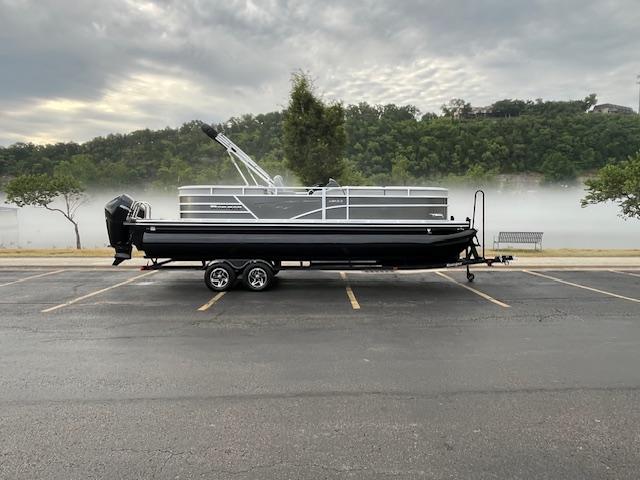 2025 Ranger Reata 243C pontoon boat on trailer, foggy landscape.