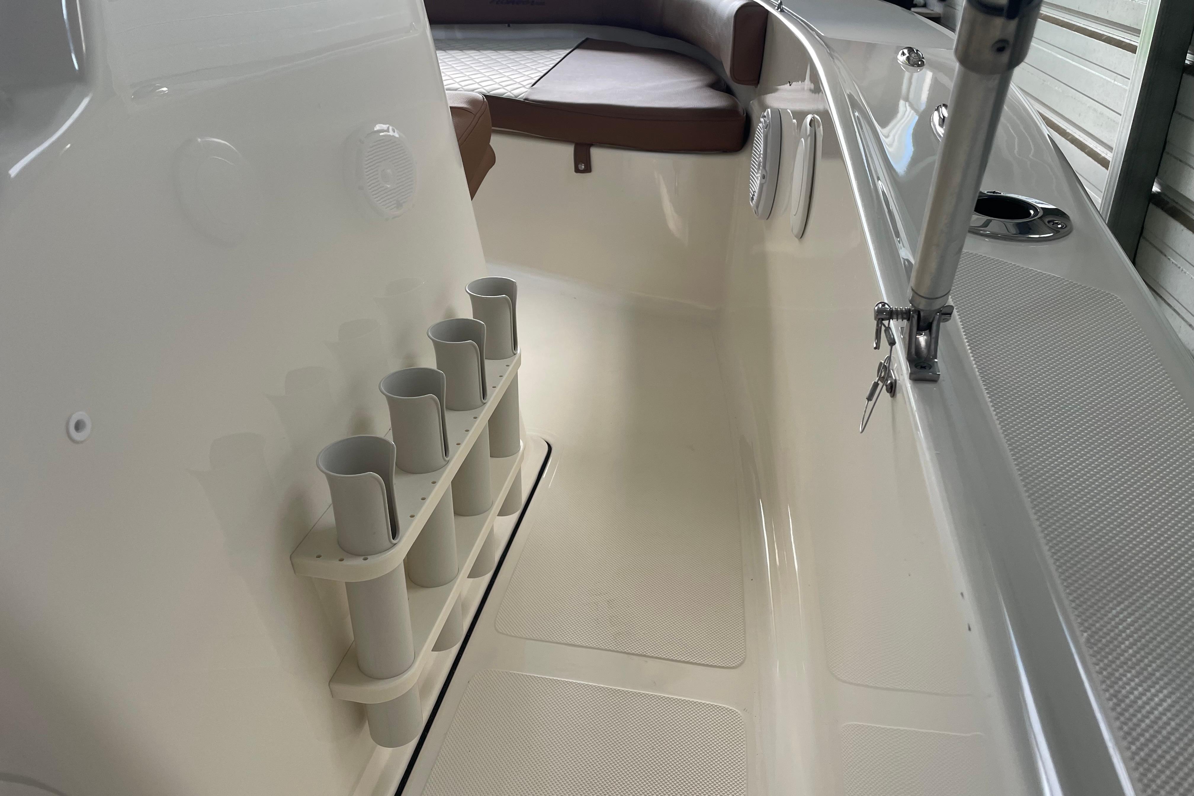 Interior view of 2024 Pioneer 180 Islander boat with rod holders and seating.