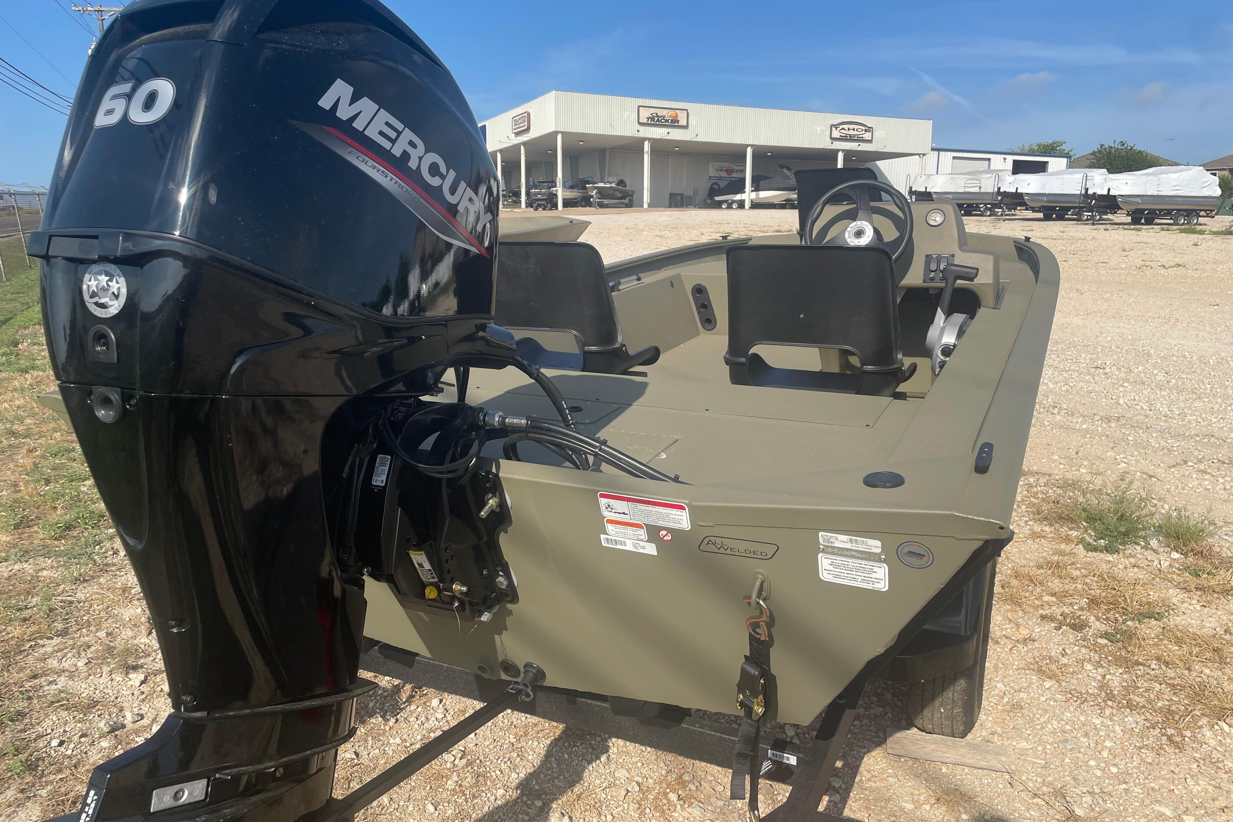 2026 Tracker Grizzly 1754 SC boat with Mercury 60 engine, parked outdoors.