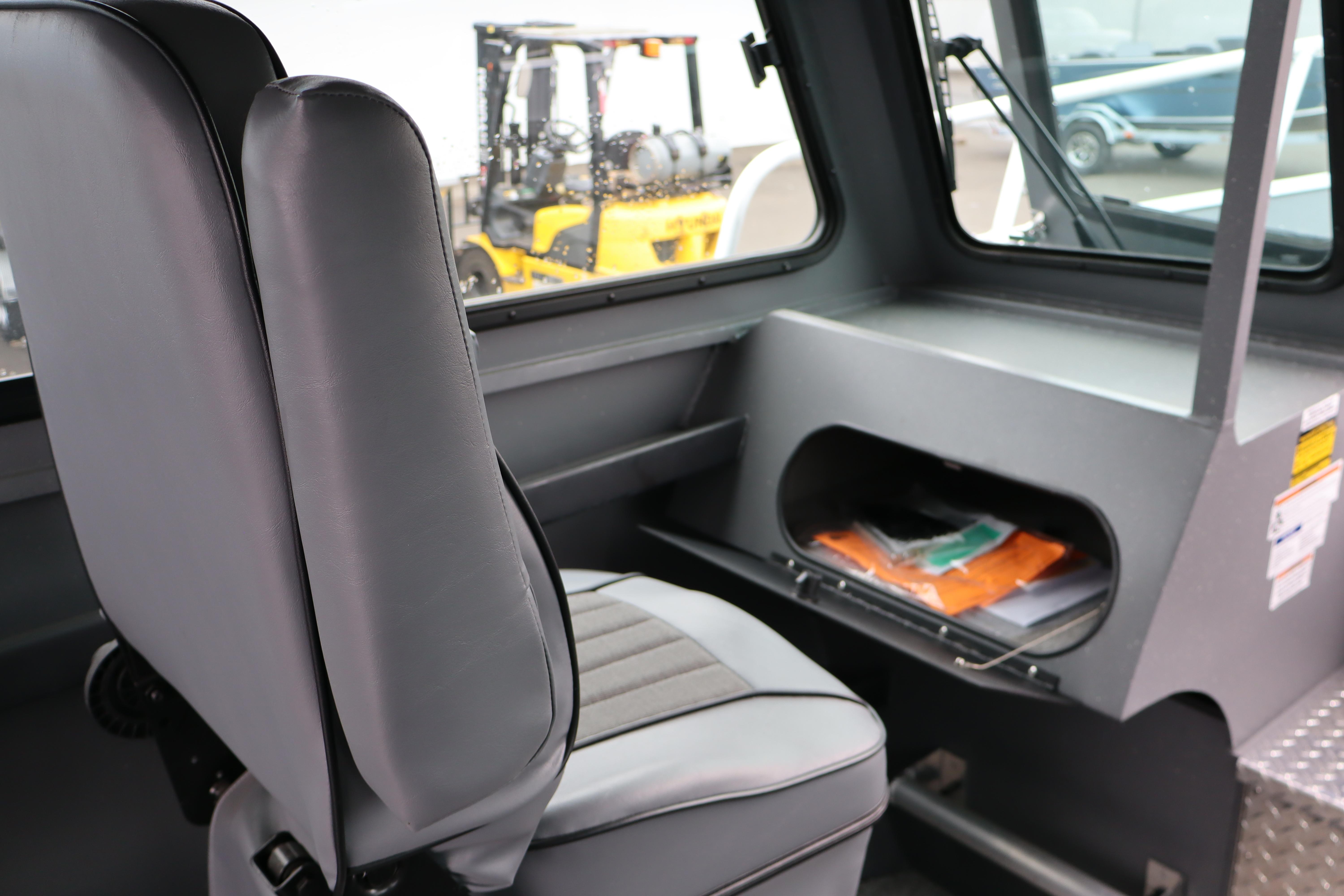 Interior of 2026 Alumaweld Horizon 24 boat with gray seating and storage compartment.