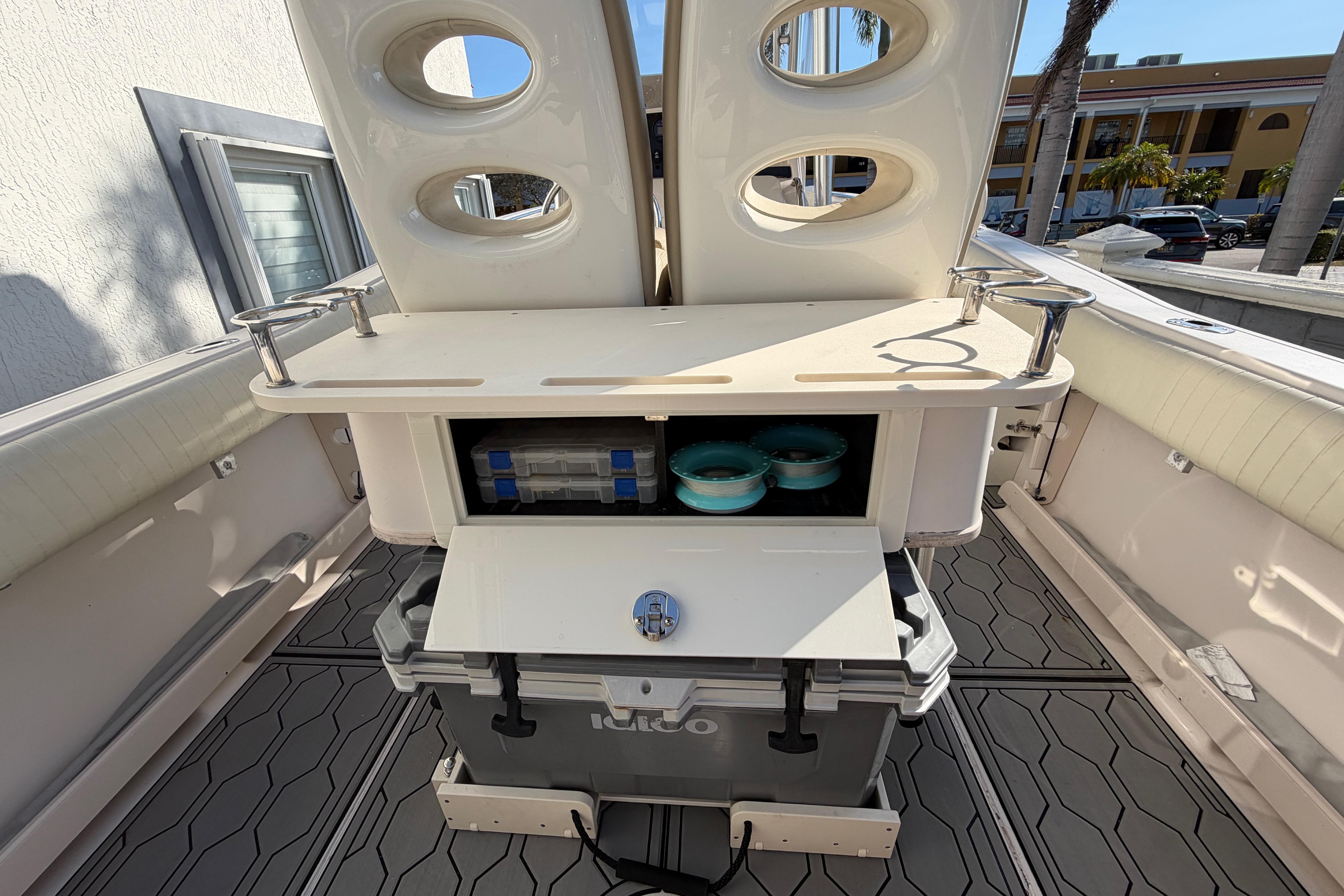 2004 Grady White 273 boat interior with storage compartments and cooler.