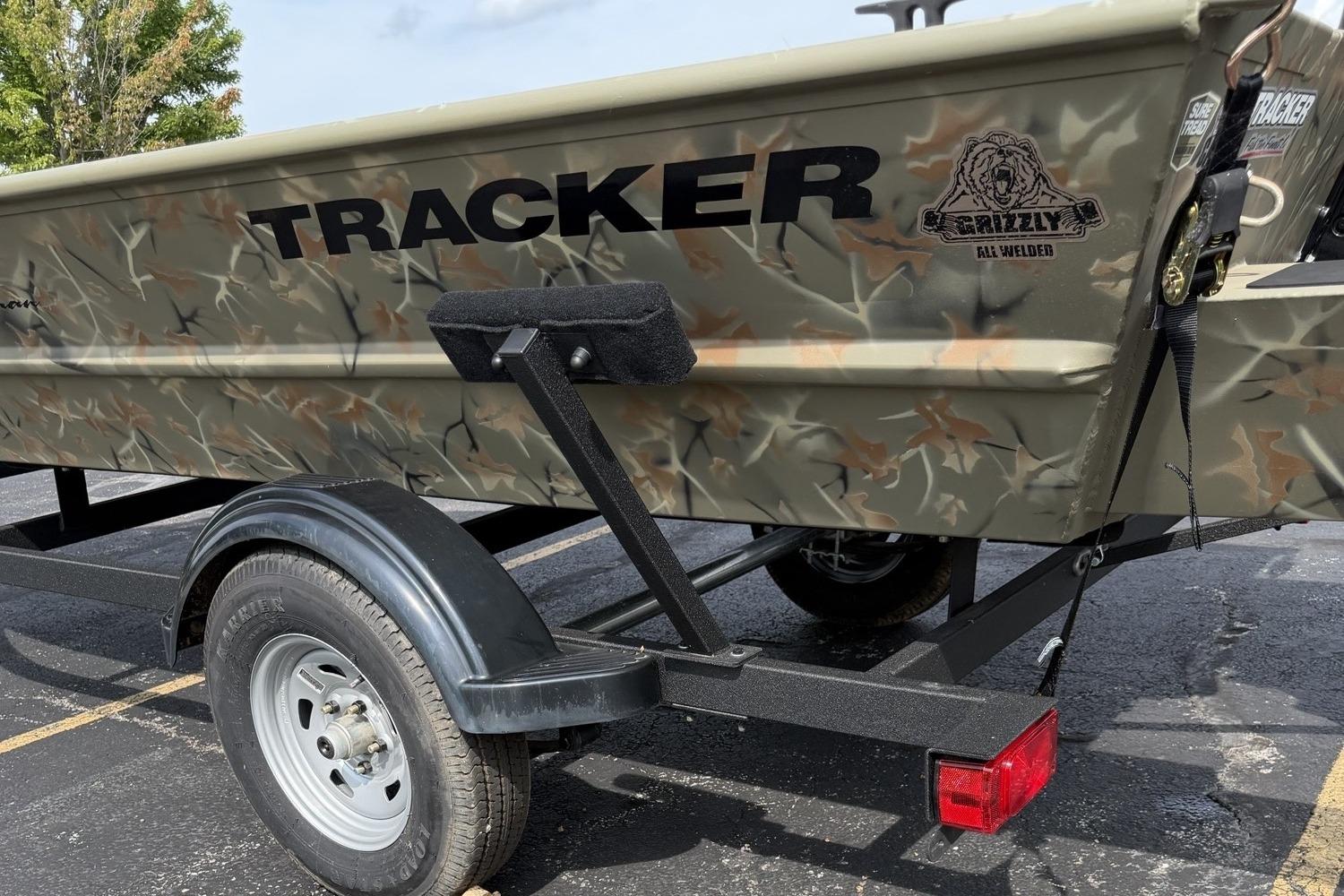 2025 Tracker Grizzly 1654 T Sportsman boat on trailer, featuring camo design and sturdy build.
