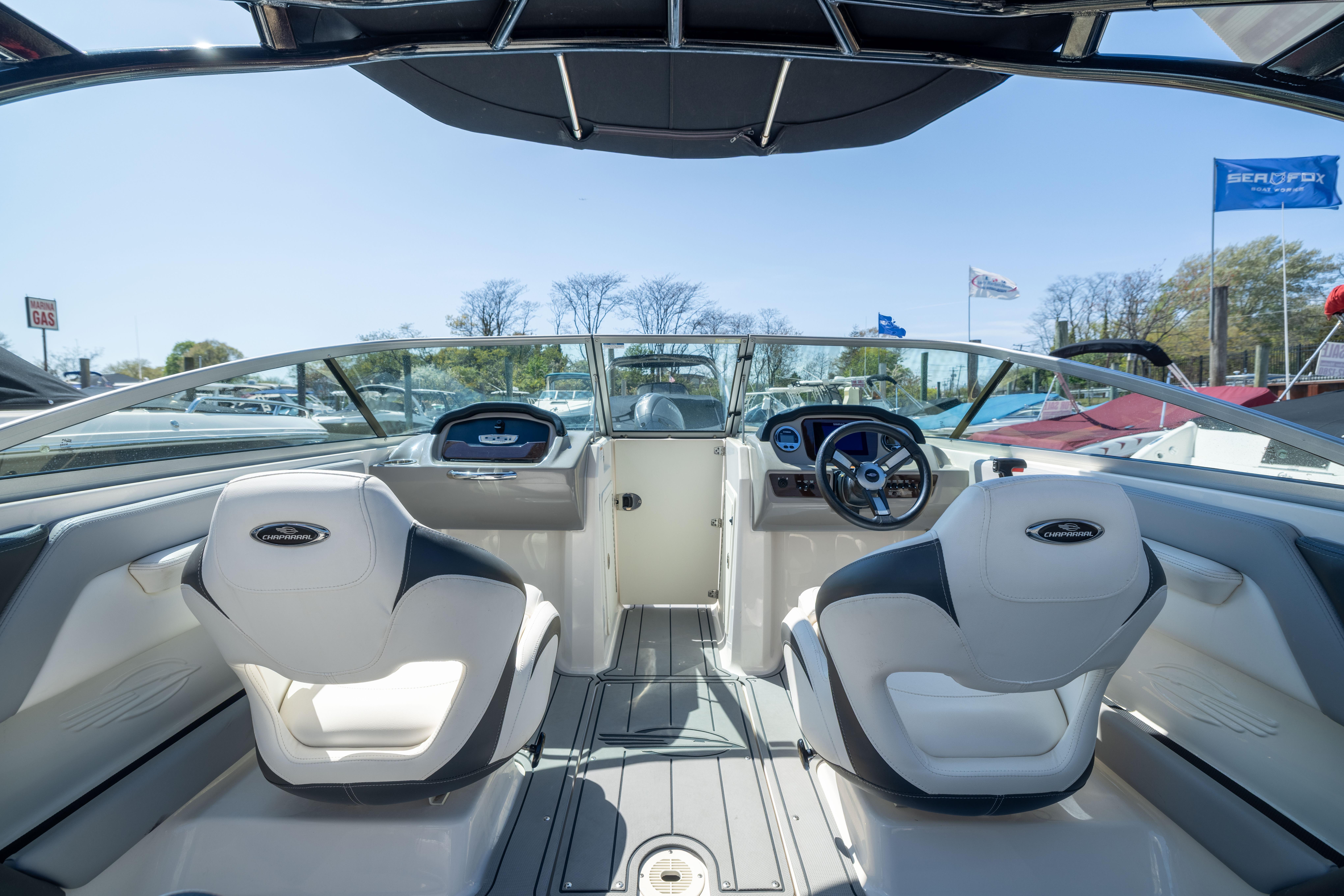 Interior view of 2022 Chaparral 21 SSi OB boat with modern dashboard and seating.