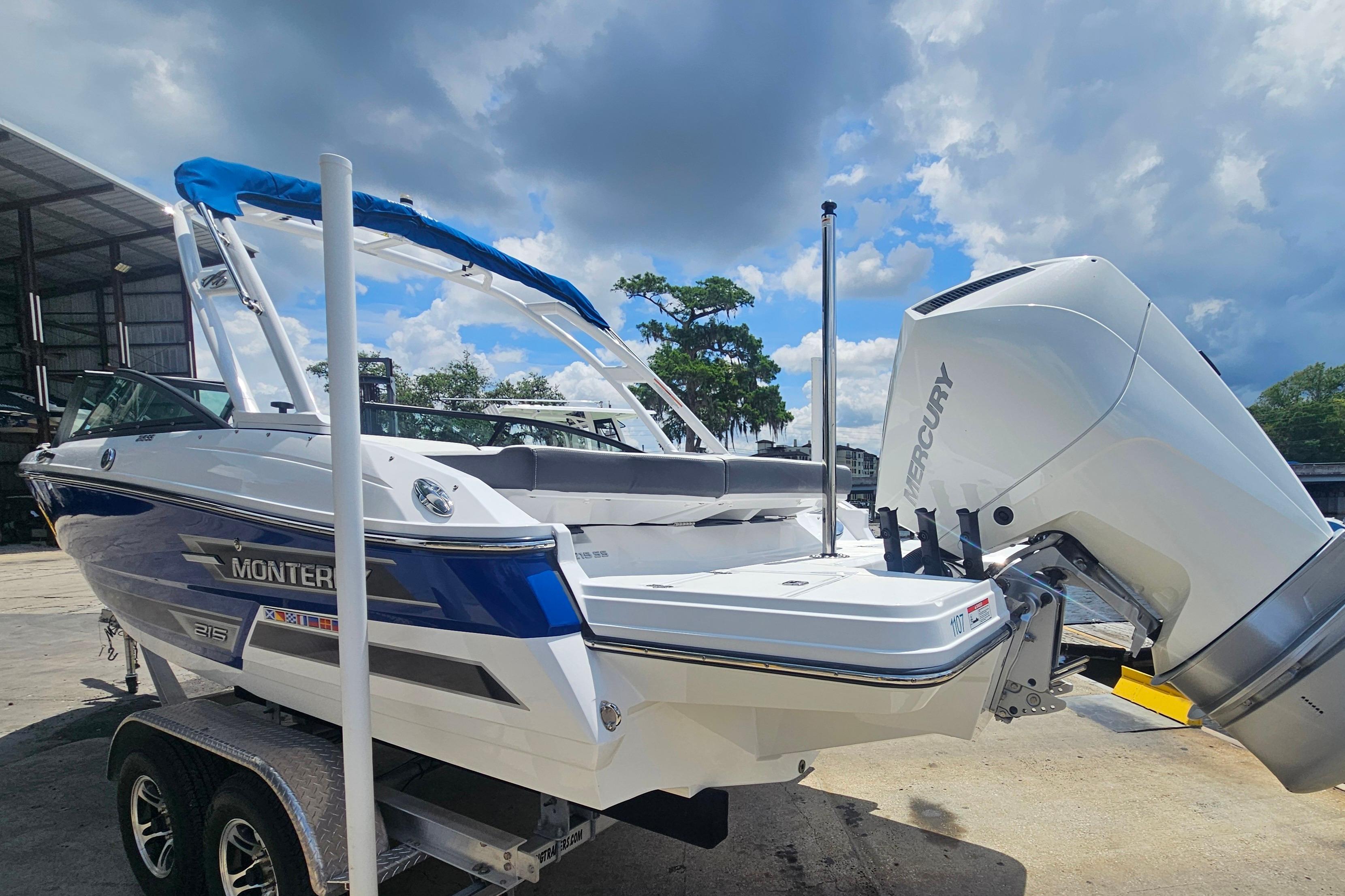 2024 Monterey 215SS Super Sport boat with Mercury engine, parked outdoors under a cloudy sky.