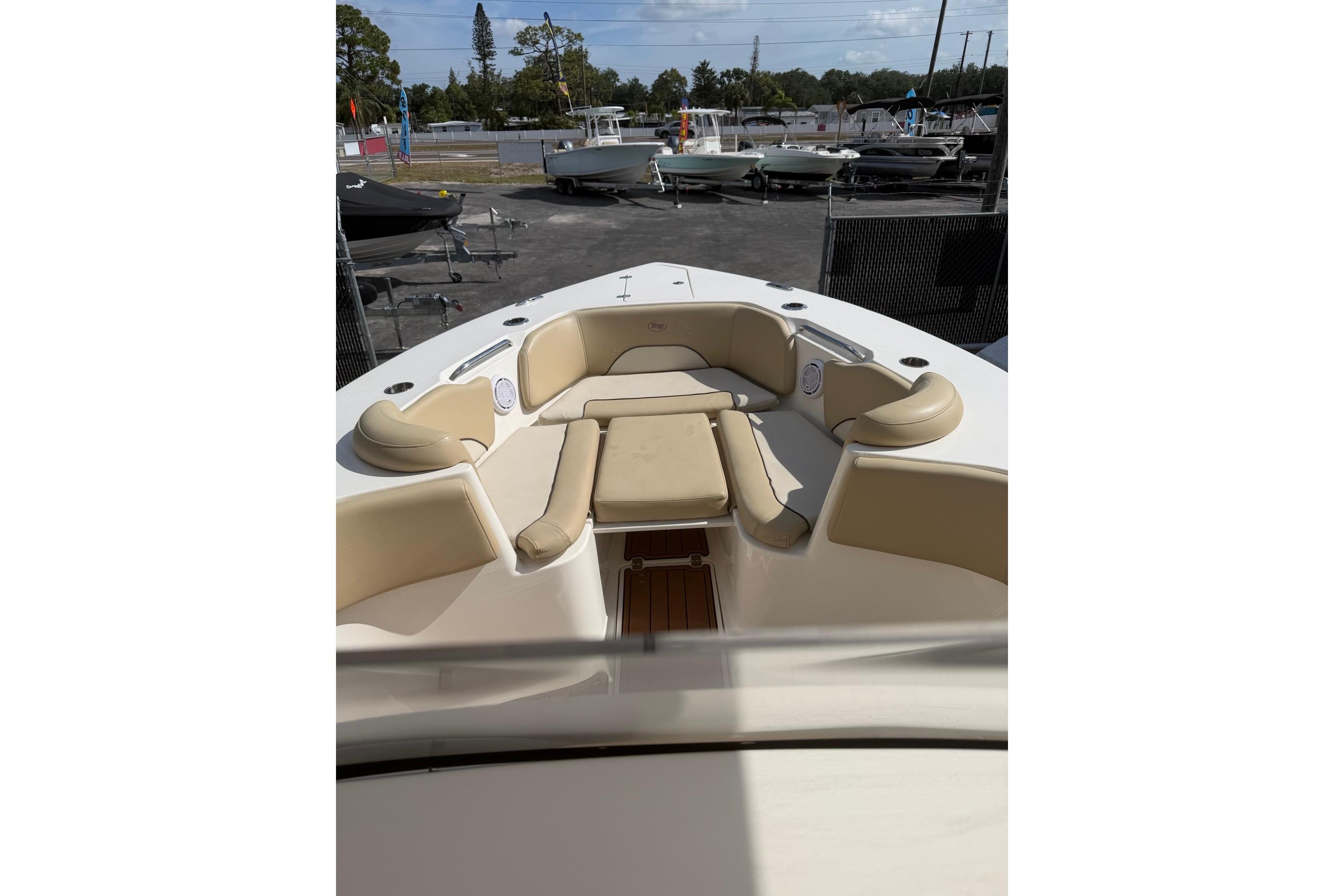 2019 Key West 263 FS boat with beige seating, docked in a marina.