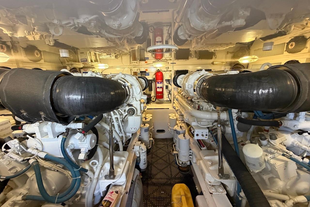 Engine room of 2012 Viking 50 Convertible yacht, featuring dual engines and fire extinguisher.