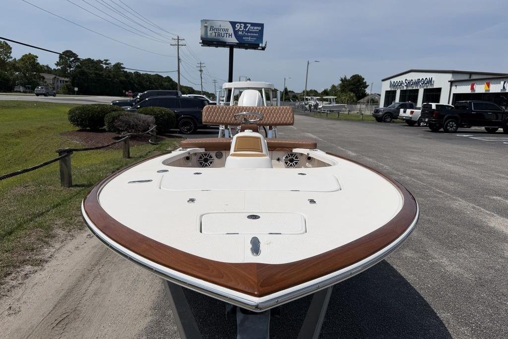 2012 Chaos 16 Bonefish boat with sleek design, parked outdoors near showroom.