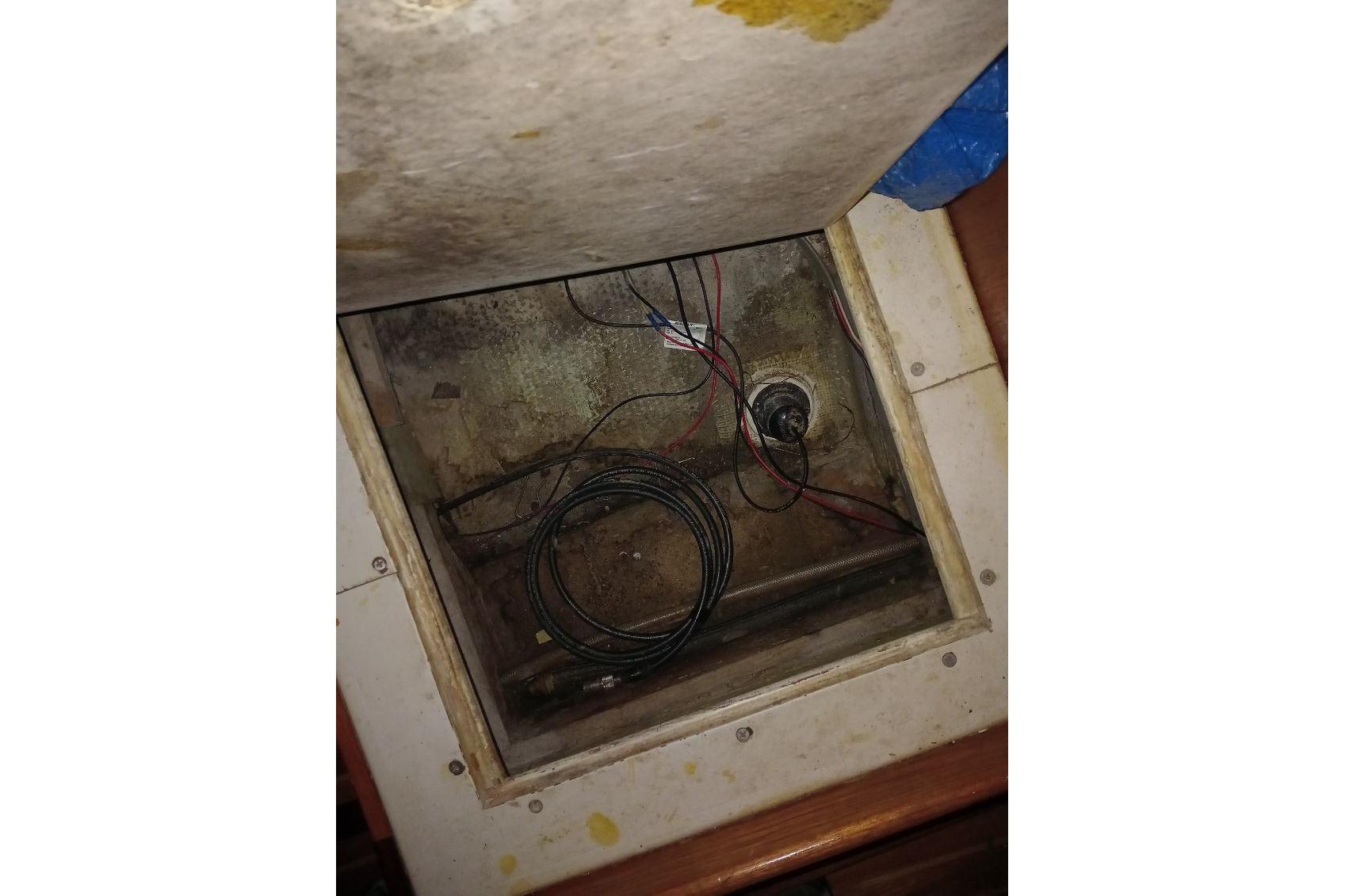 Open compartment in 1974 C&C 35 boat showing wiring and cables.
