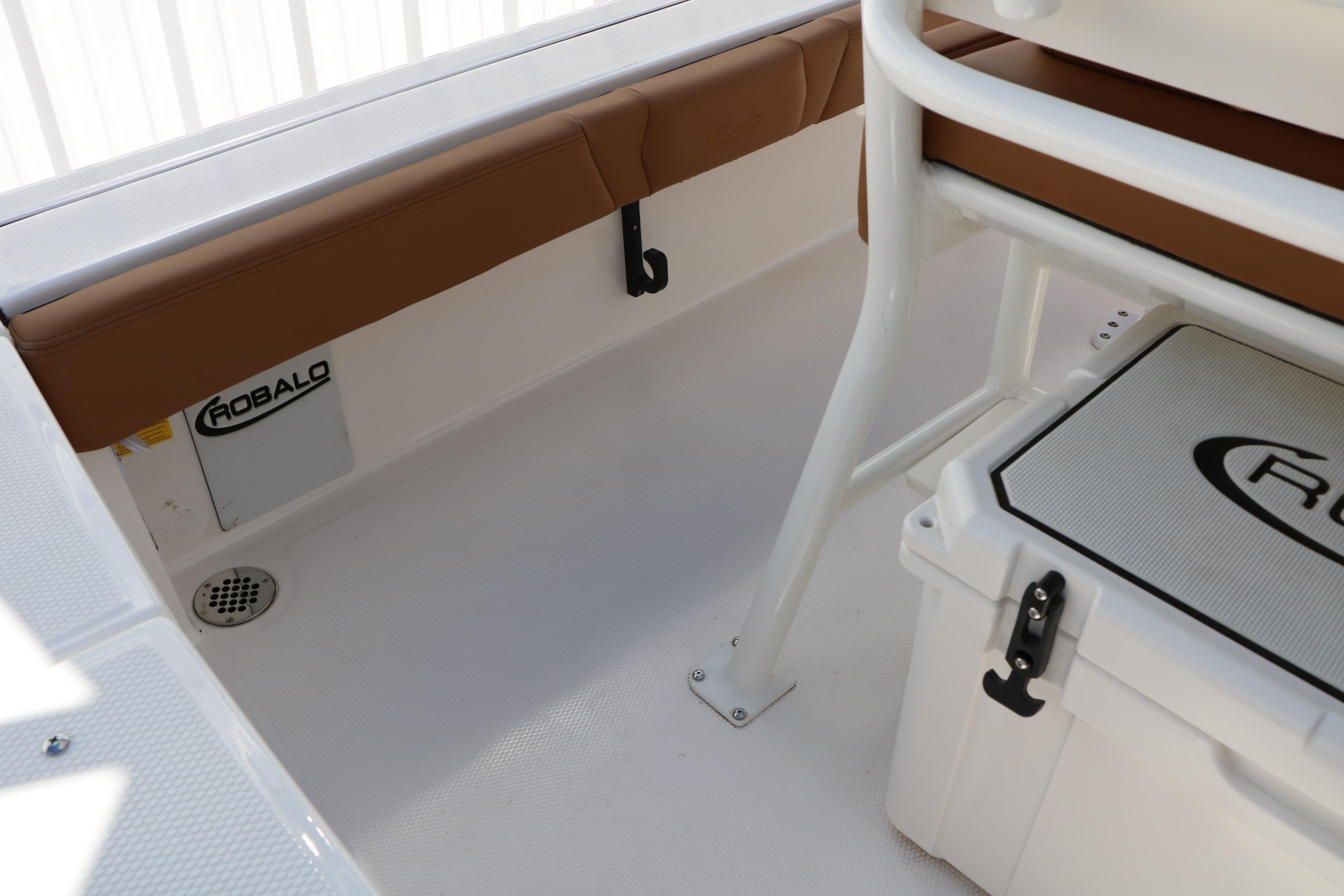 Interior view of 2026 Robalo 246 Cayman boat, featuring seating and storage.