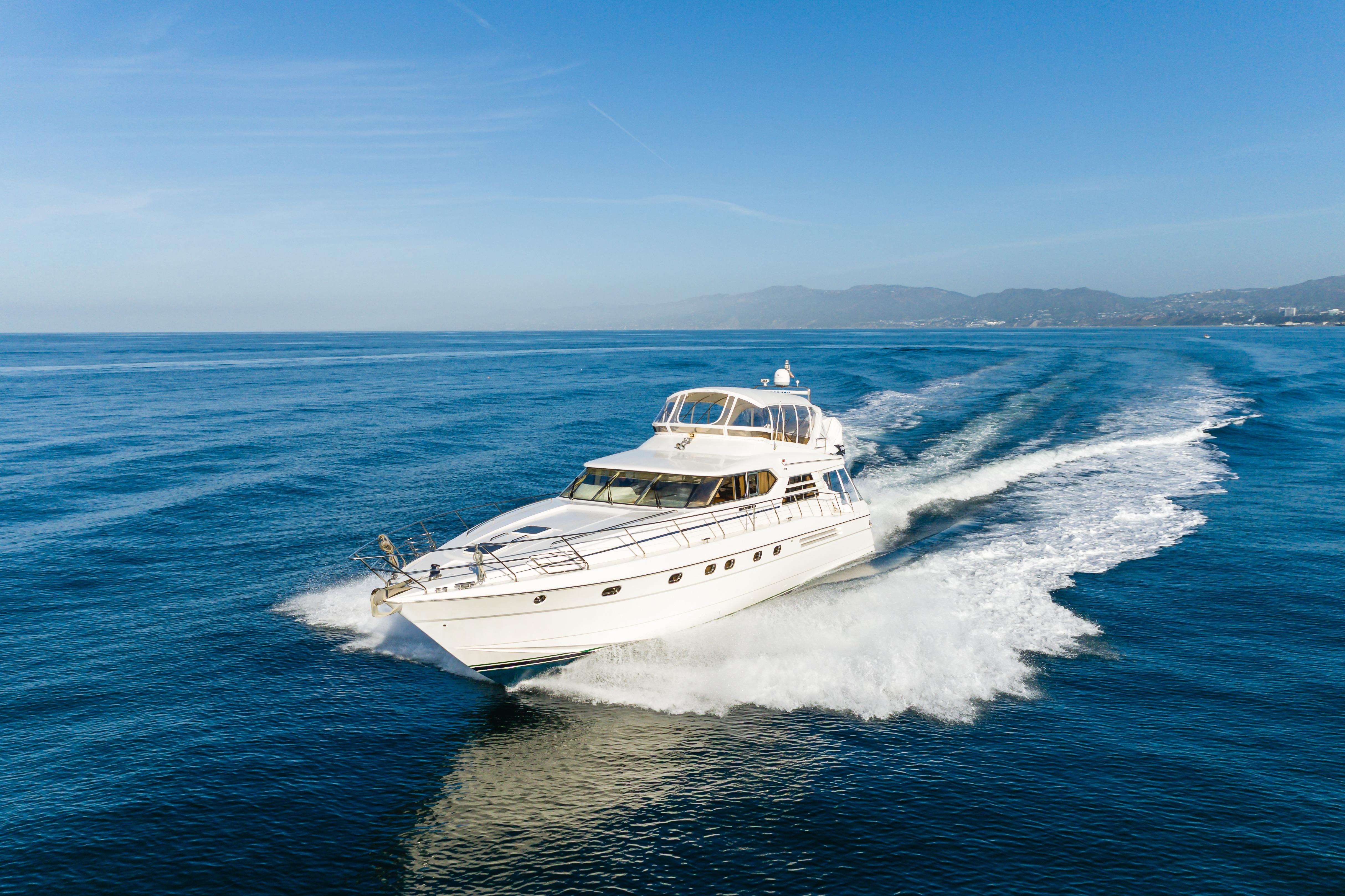 1997 Viking Sport Cruisers 66 Motor Yacht cruising on open blue sea.