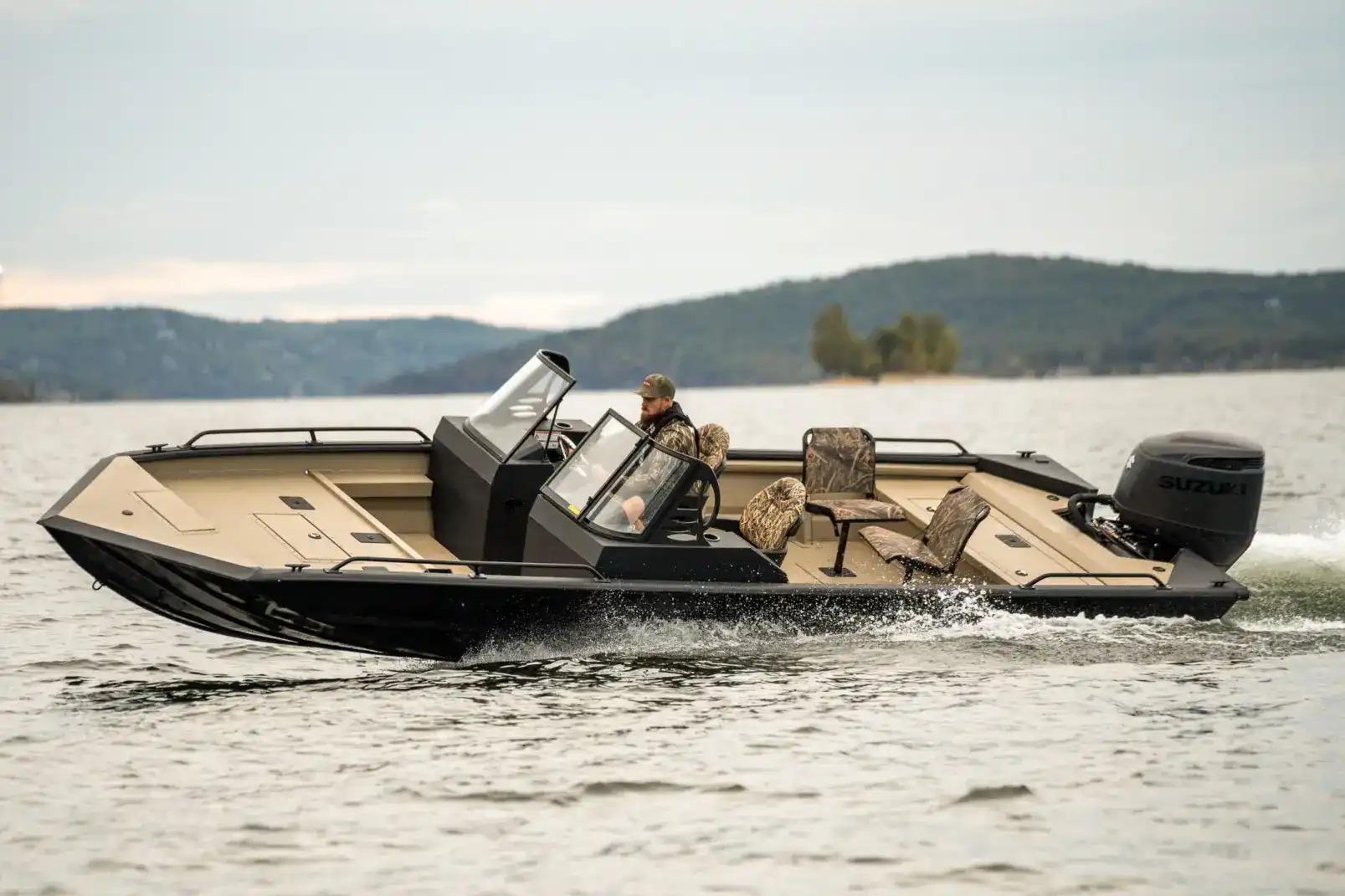Manufacturer Provided Image: 2026 SeaArk Protege 240 boat cruising on a lake with scenic hills in the background.