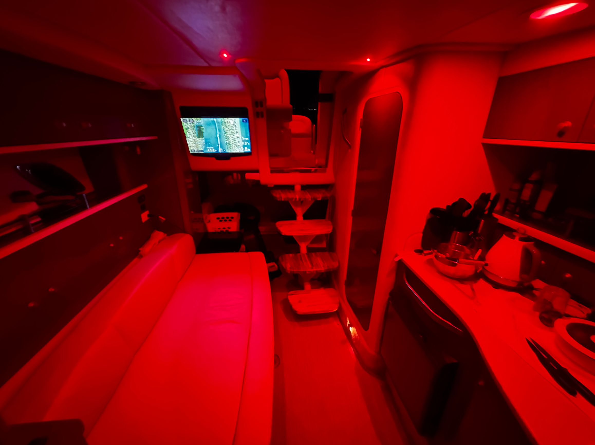 Interior of 2008 Sea Ray Sundancer 310 yacht, illuminated in red lighting.