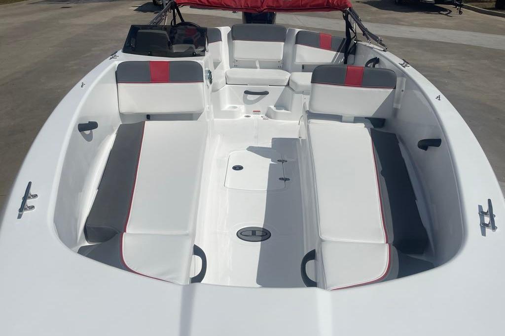 2026 Tahoe T18 boat interior with white and gray seating, red accents, and spacious layout.