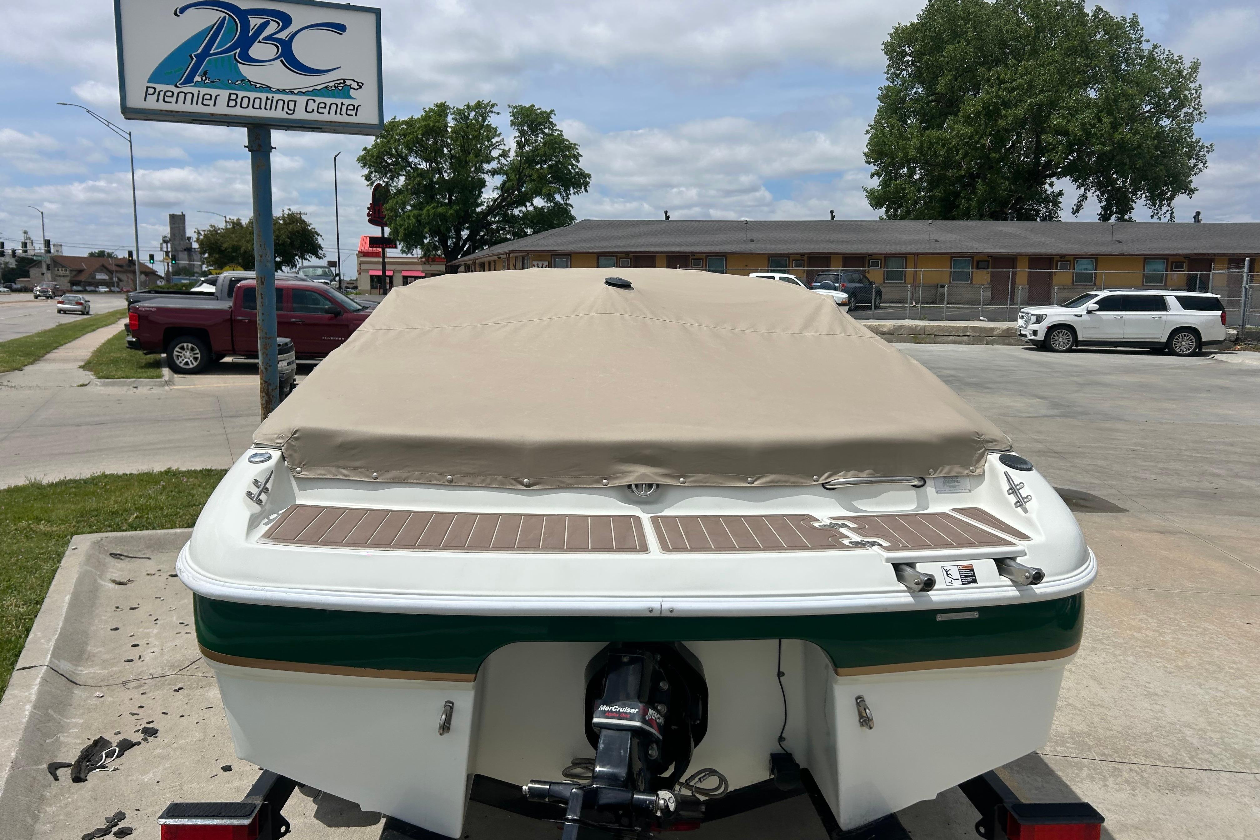Covered 2000 Starcraft 1810 boat at Premier Boating Center parking lot.