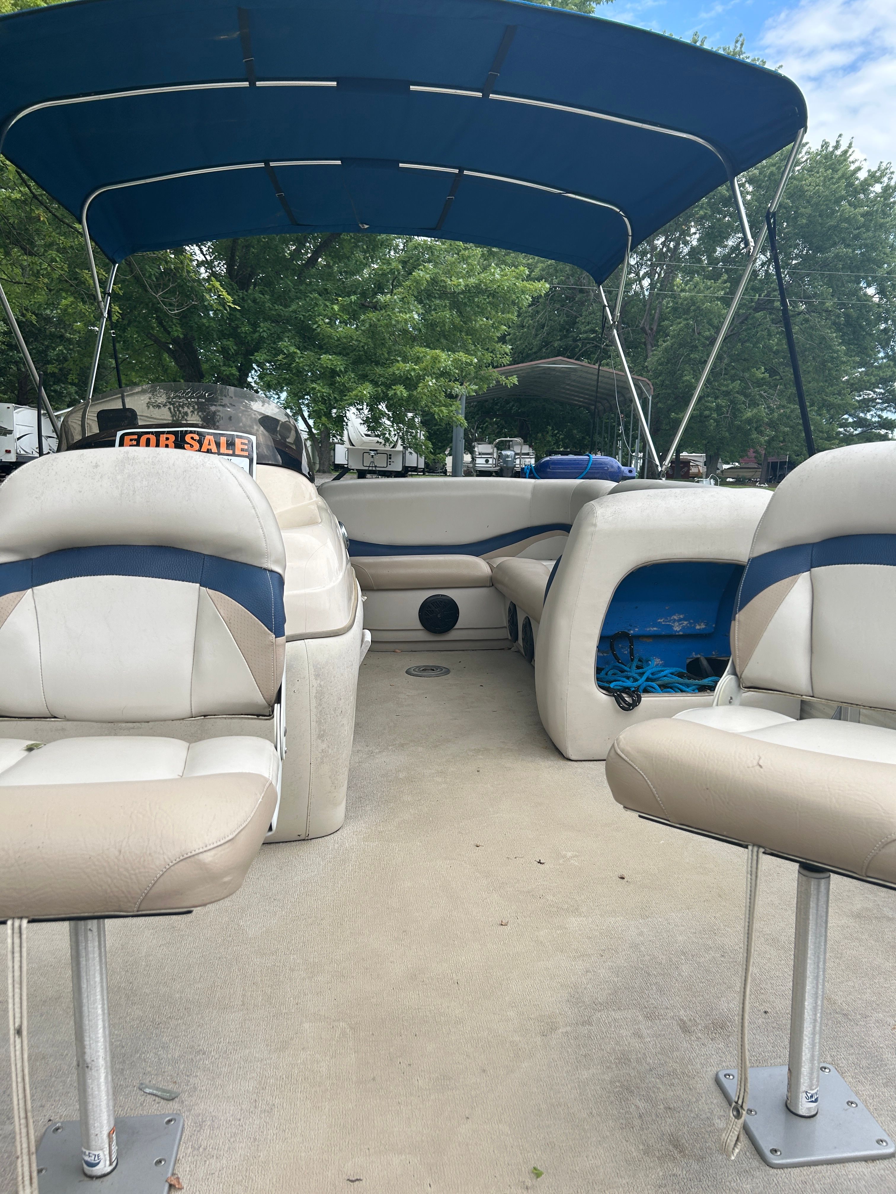 Interior view of a 2008 Sun Tracker Fishin' Barge 21' with seating and canopy.
