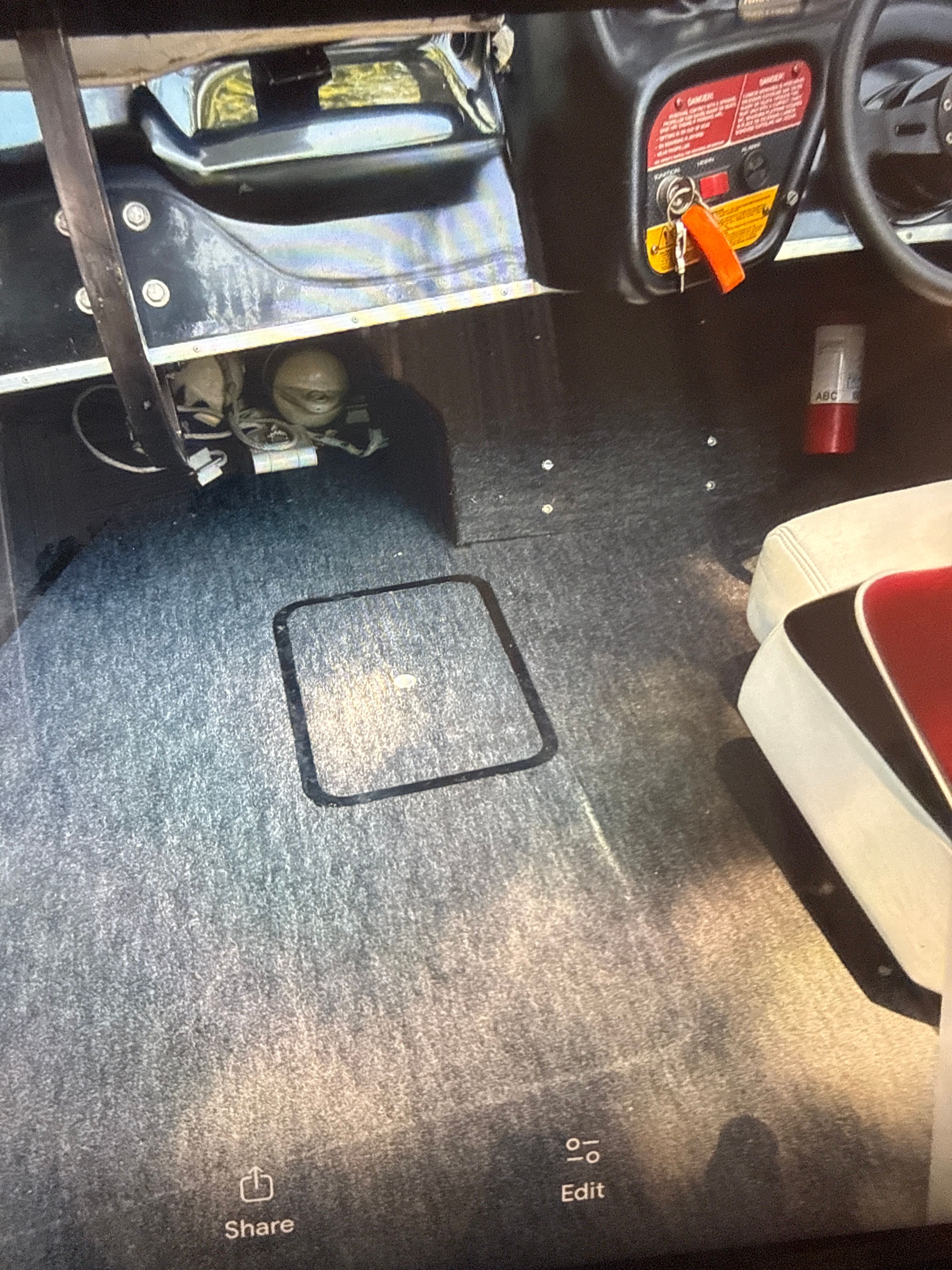 Interior of a 1990 Correct Craft Ski Nautique boat with carpeted floor.