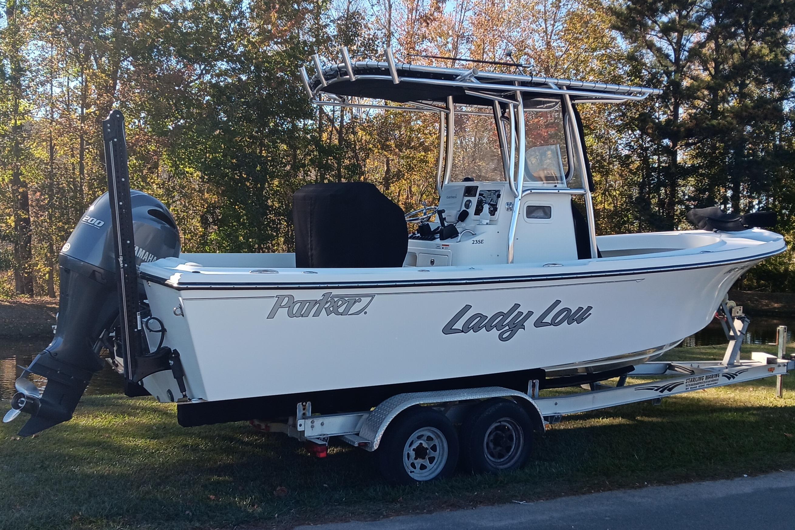 2016 Parker 2300 Special Edition boat on trailer, named "Lady Lou," in a wooded area.