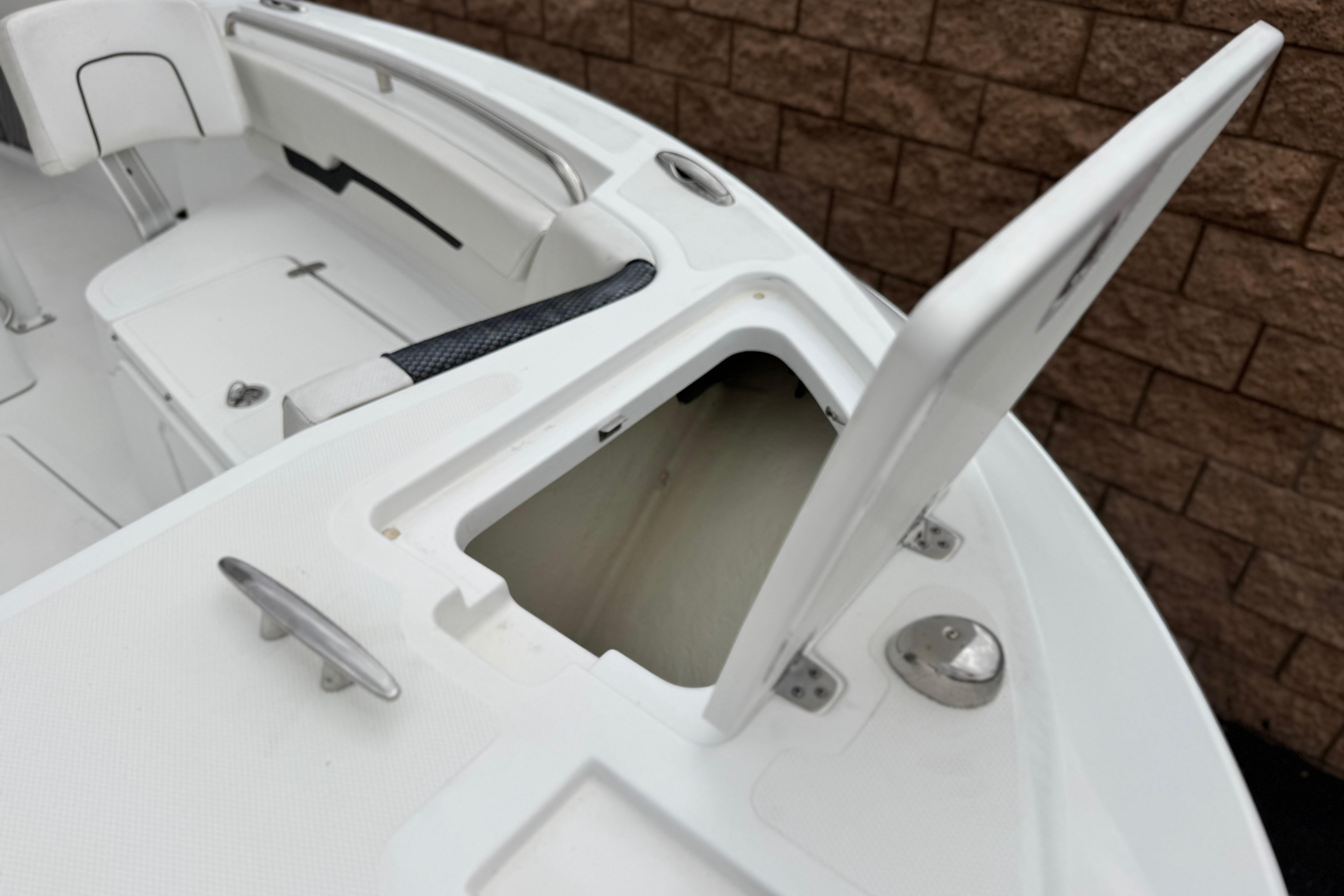 2022 Wellcraft 222 Scarab Offshore boat with open storage compartment and seating.