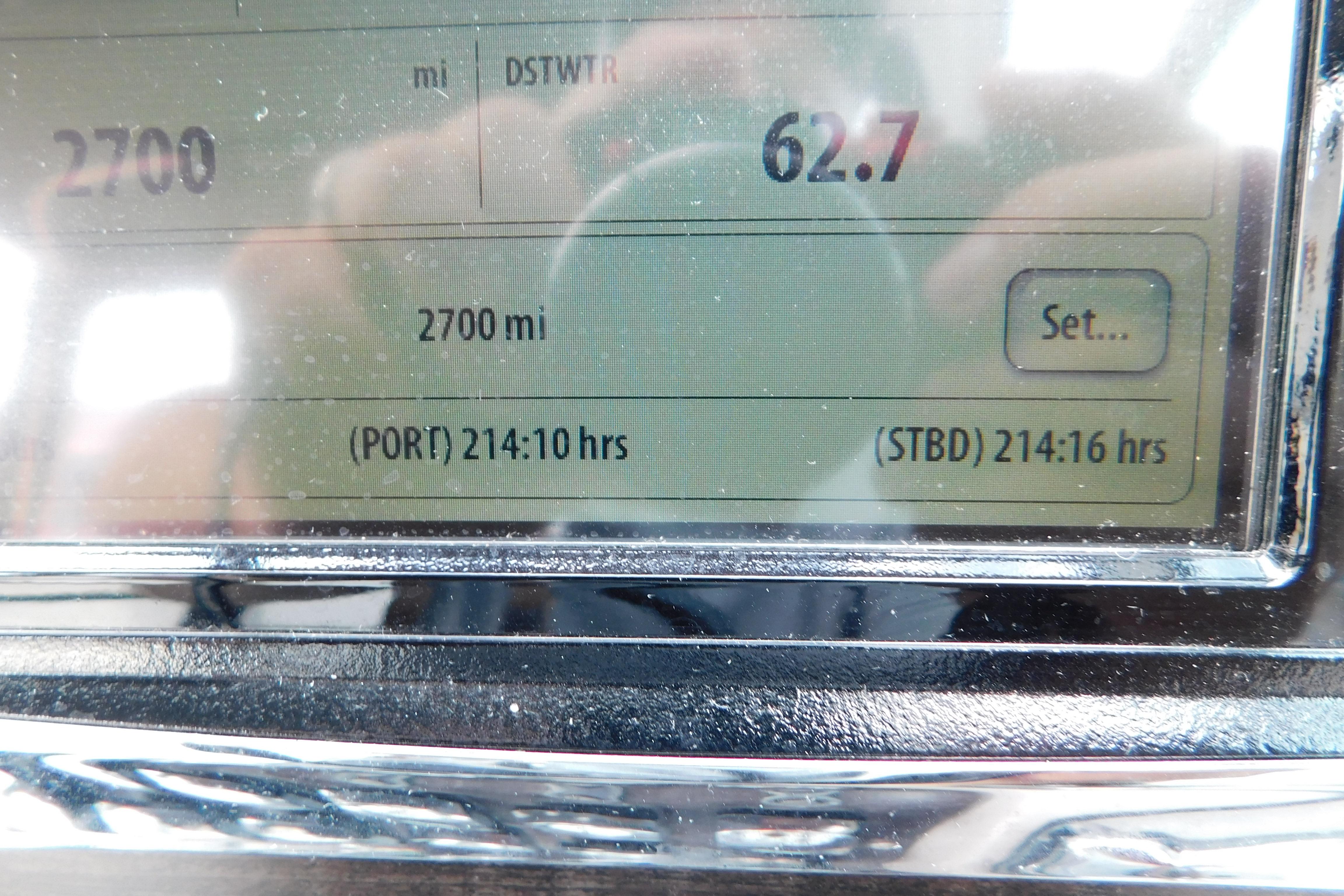 Close-up of a 2017 Rinker EX 320 dashboard display showing 2700 miles and engine hours.