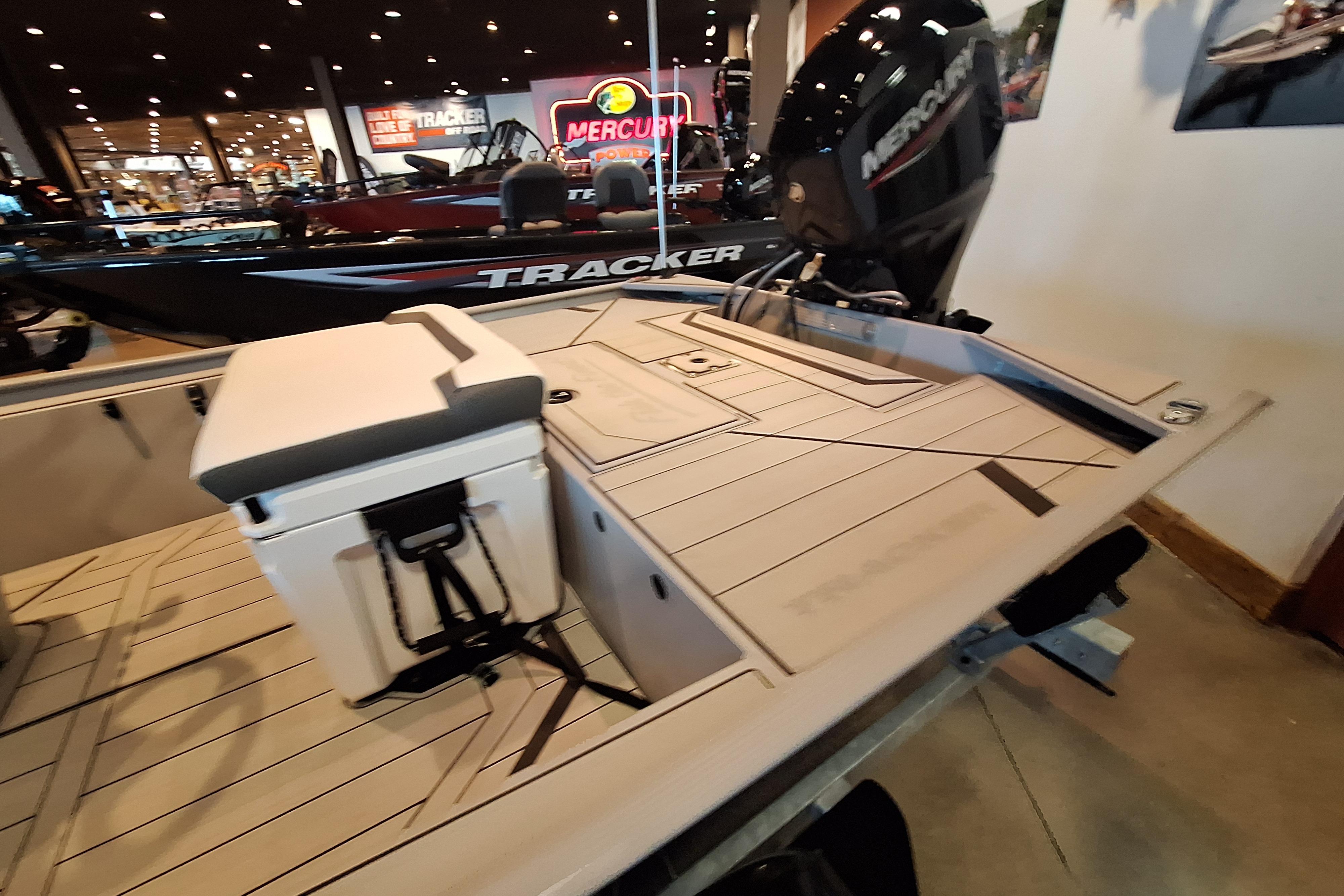 2026 Tracker Bass Tracker Classic CC boat displayed indoors with Mercury engine.