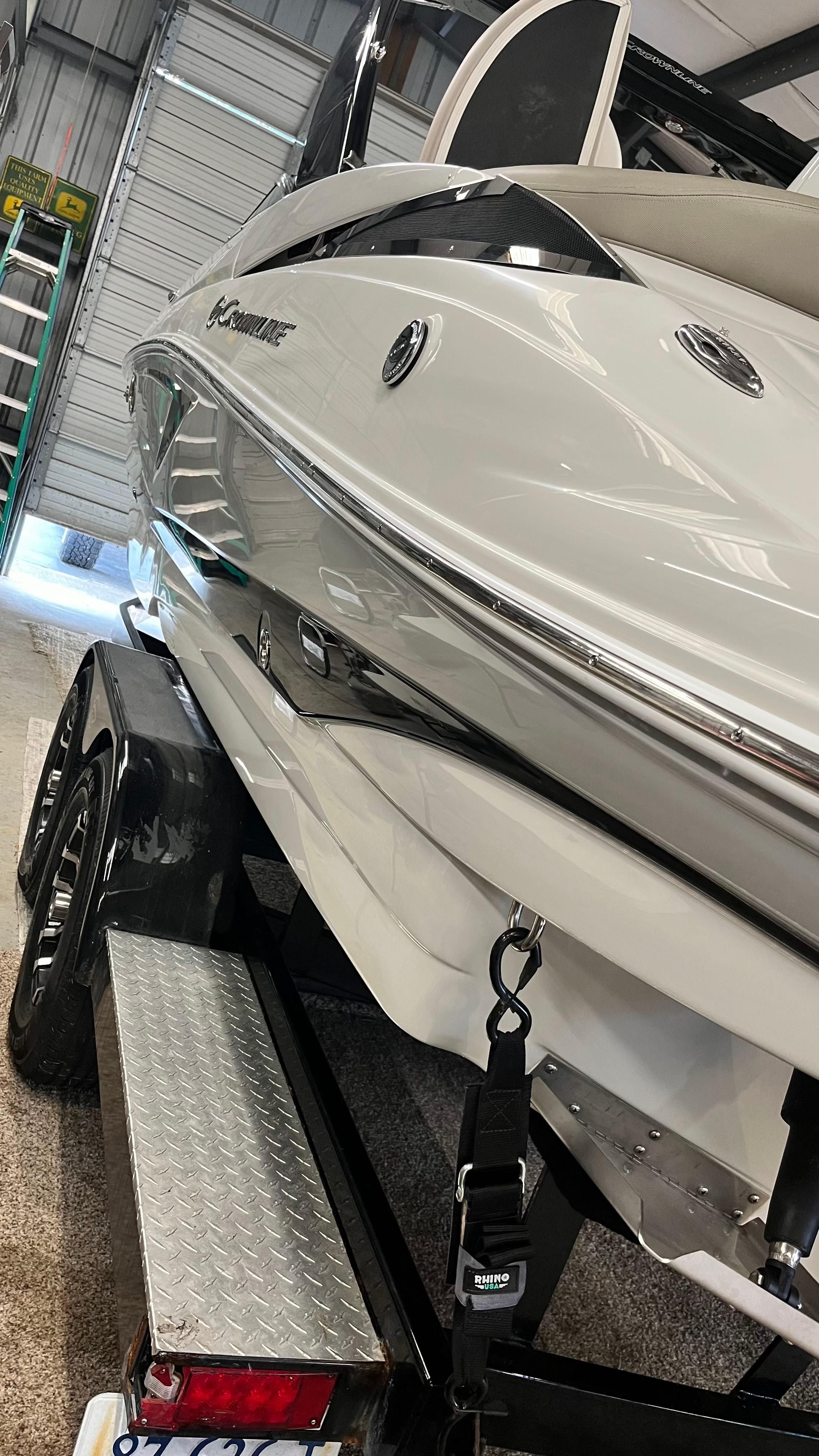 Crownline E 285 from 2019 on a trailer in a garage.