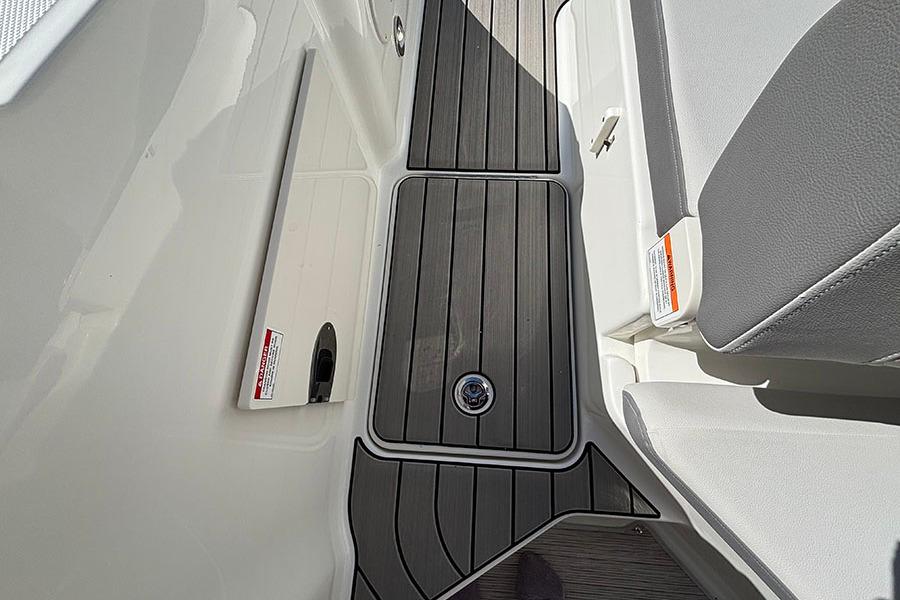 2027 Sea Ray SDX 230 Outboard boat interior with sleek gray flooring and seating.